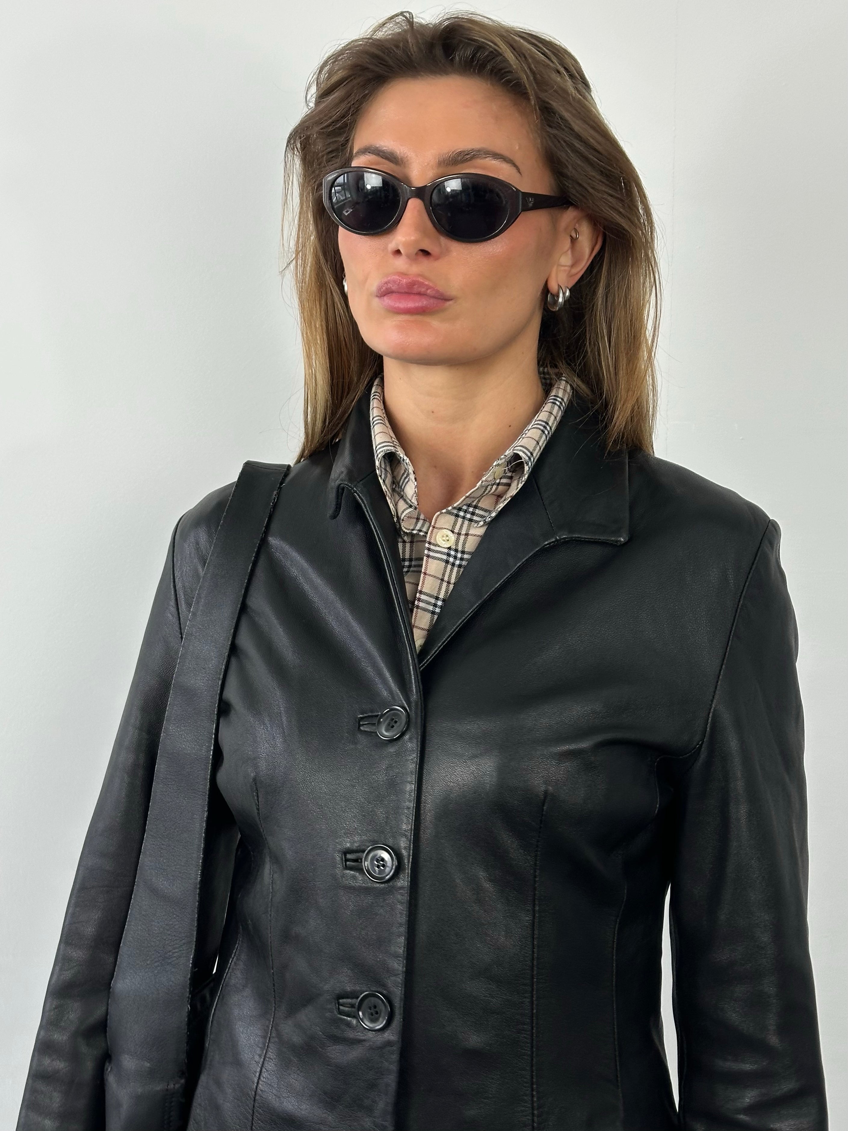 Vintage British 1990s fitted leather jacket, small size, showcasing classic style and detailed leather texture.