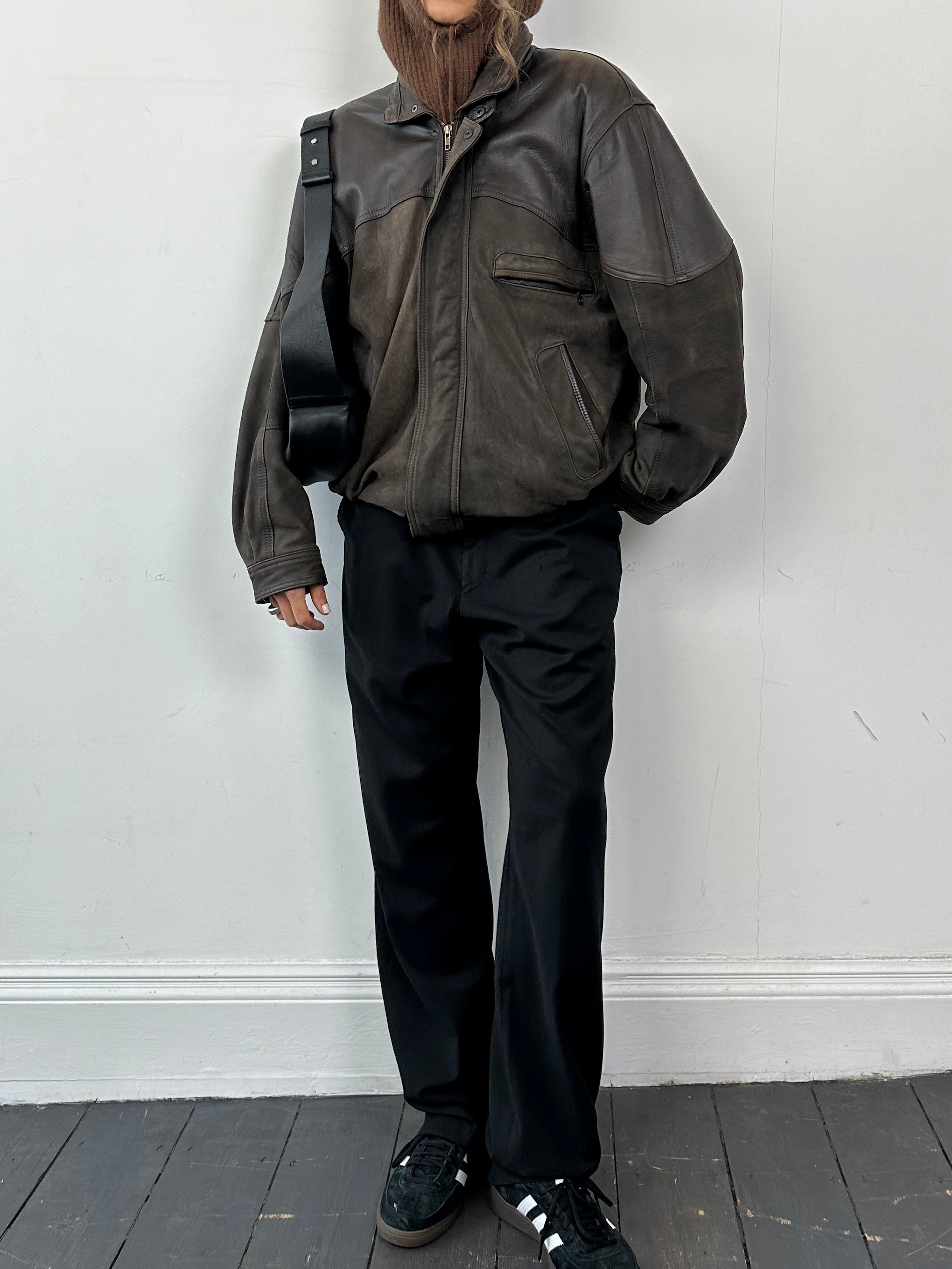 Vintage brand vintage aged leather bomber jacket in size L, featuring a classic design with a worn, distressed leather finish.