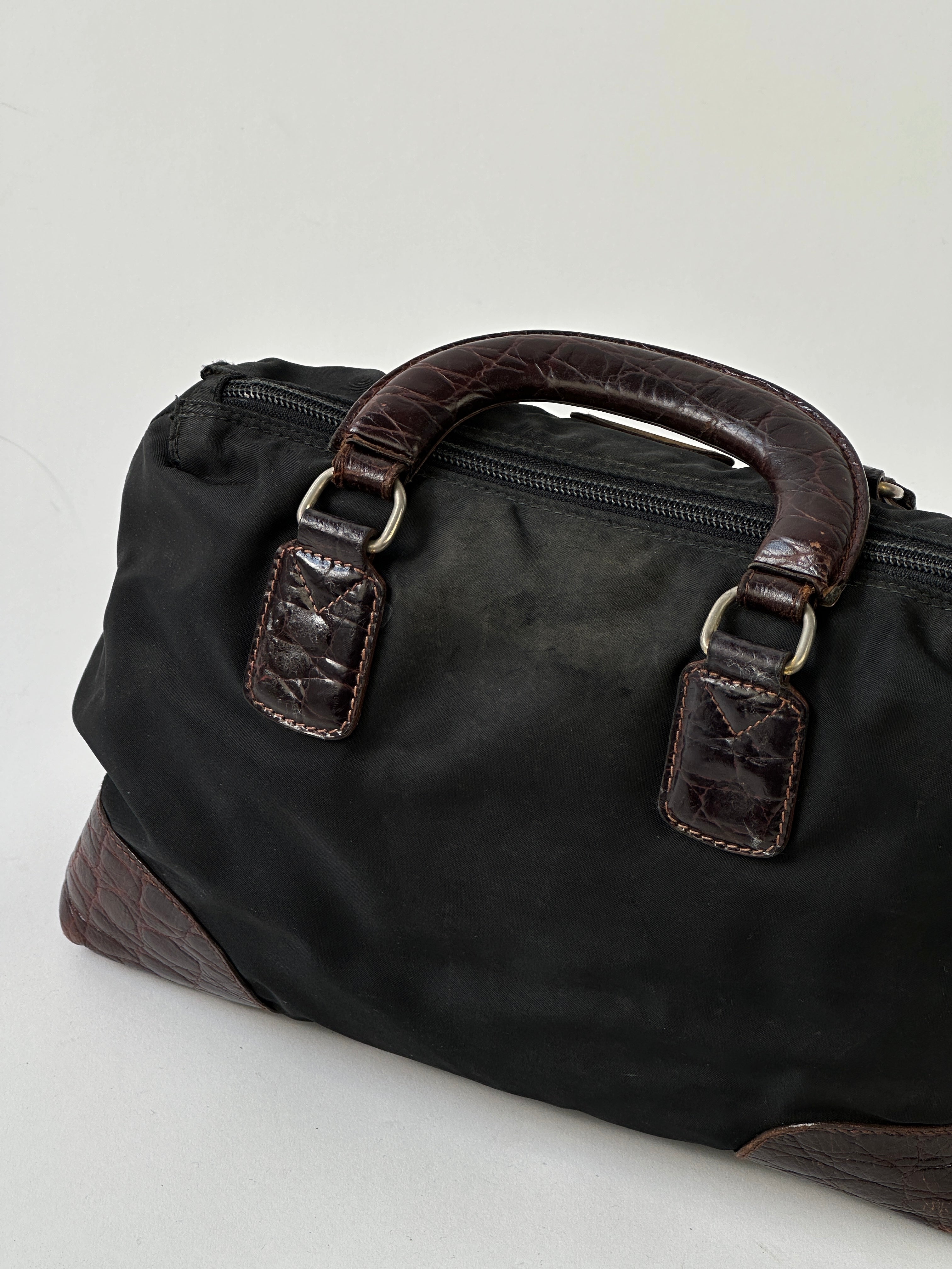 Prada nylon croc handbag featuring a sleek design, textured crocodile pattern, and elegant black nylon material.