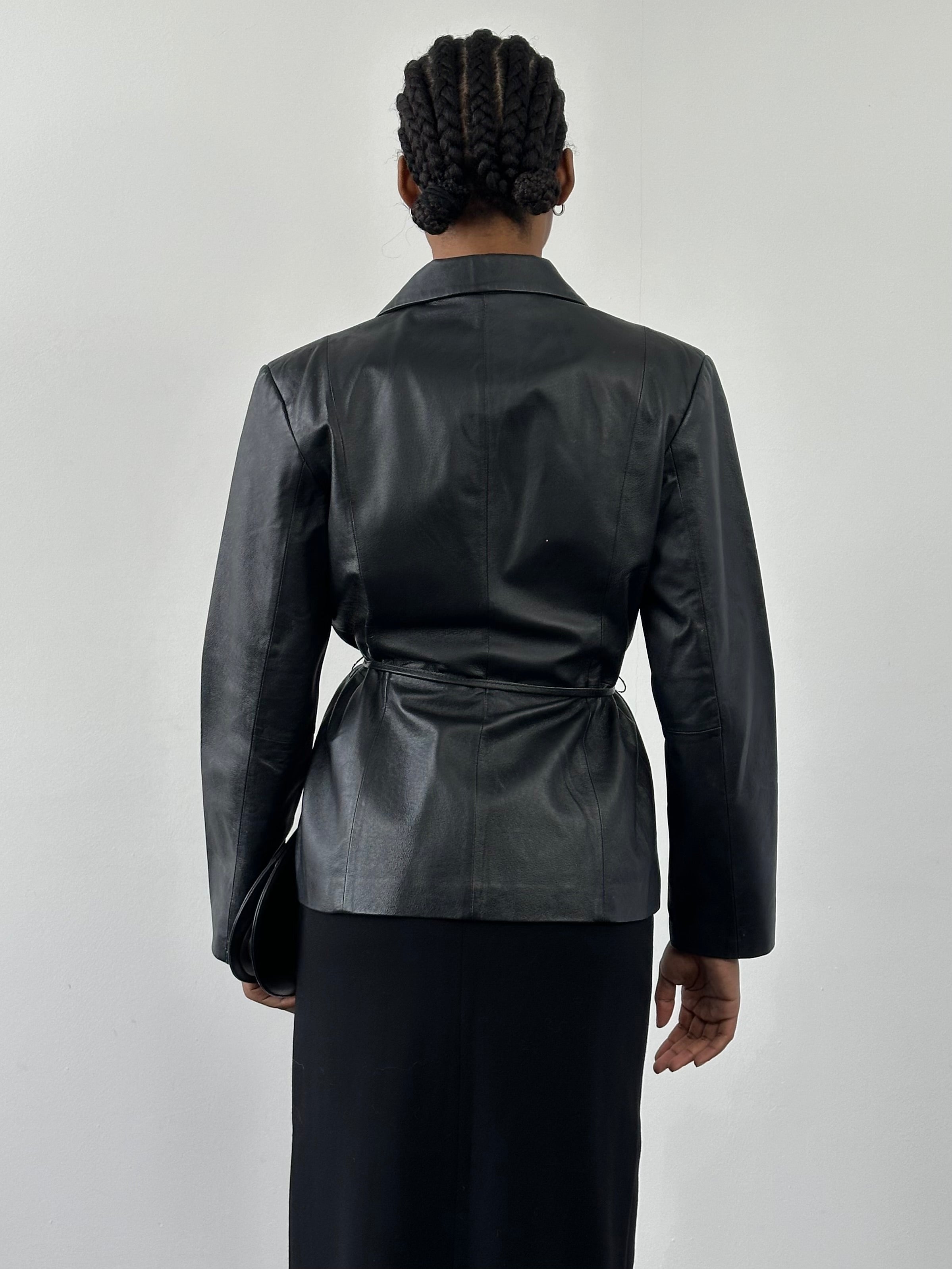 Vintage 2000s minimal leather jacket with tie belt, size small, featuring classic design and soft leather material.