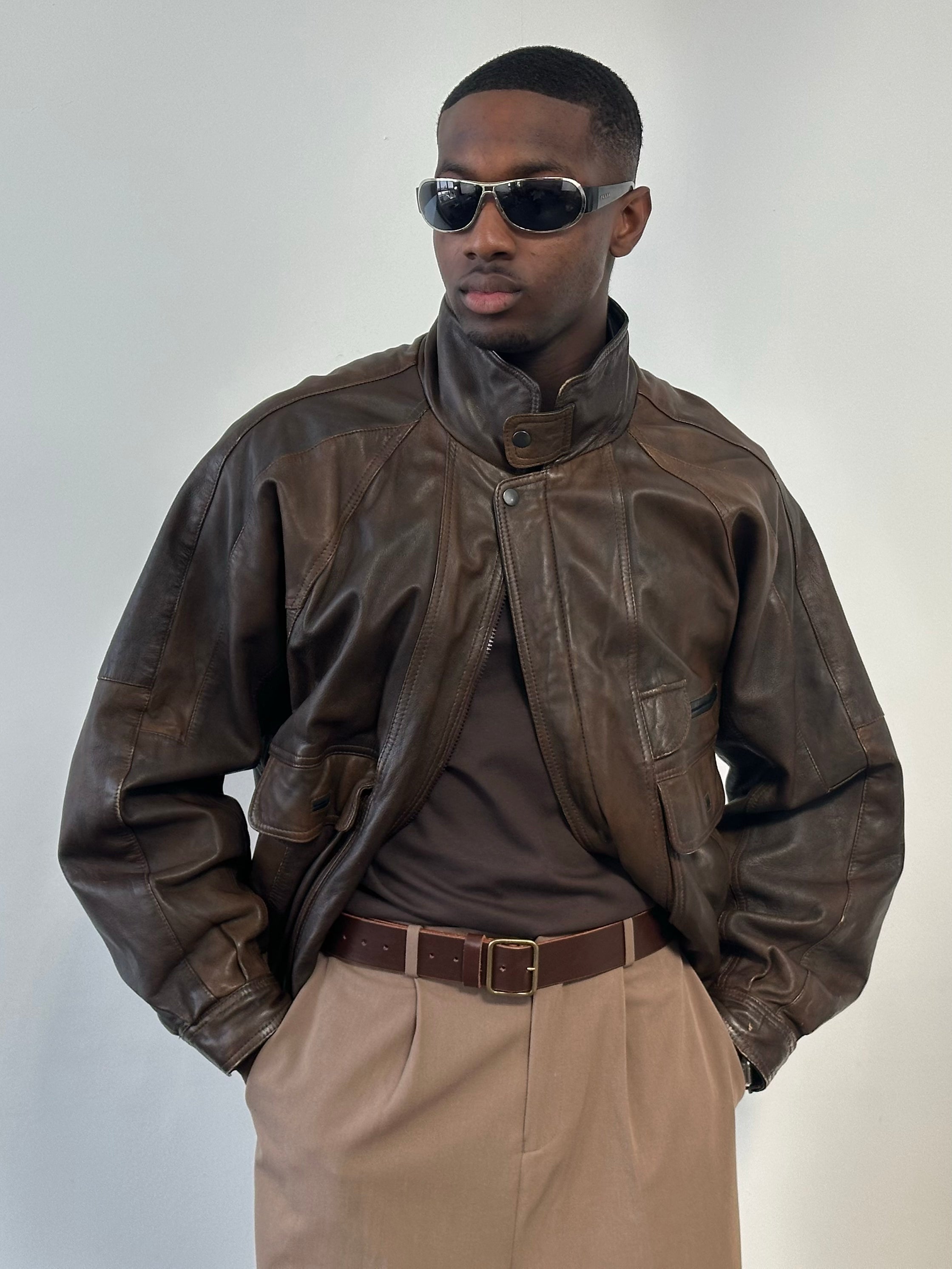 Vintage 1990s leather high-neck bomber jacket in XL, featuring classic leather texture and high collar, styled for a retro look.