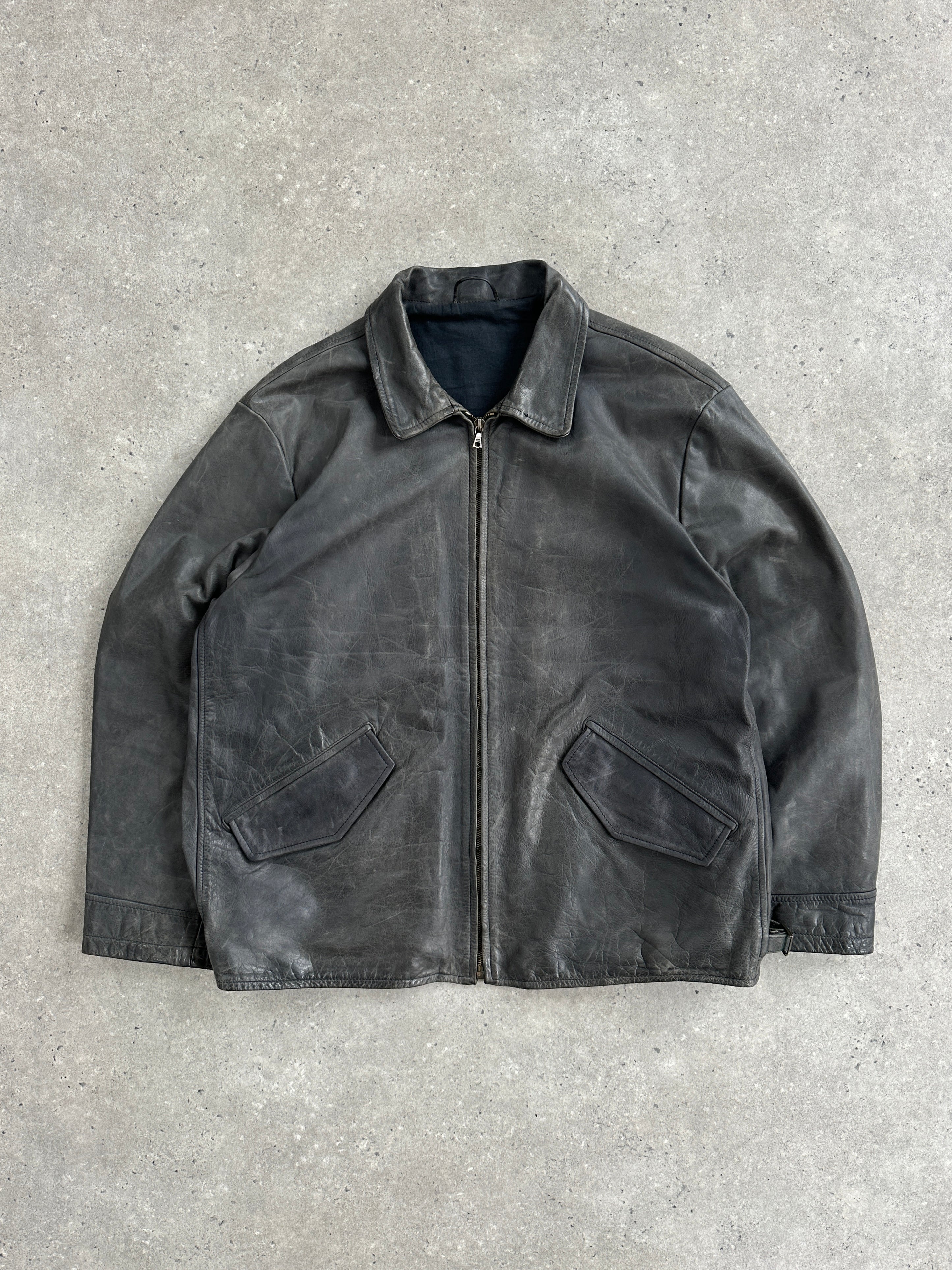 Vintage 1990s boxy leather jacket in aged brown leather, size large/extra large, with classic collar and distressed finish.