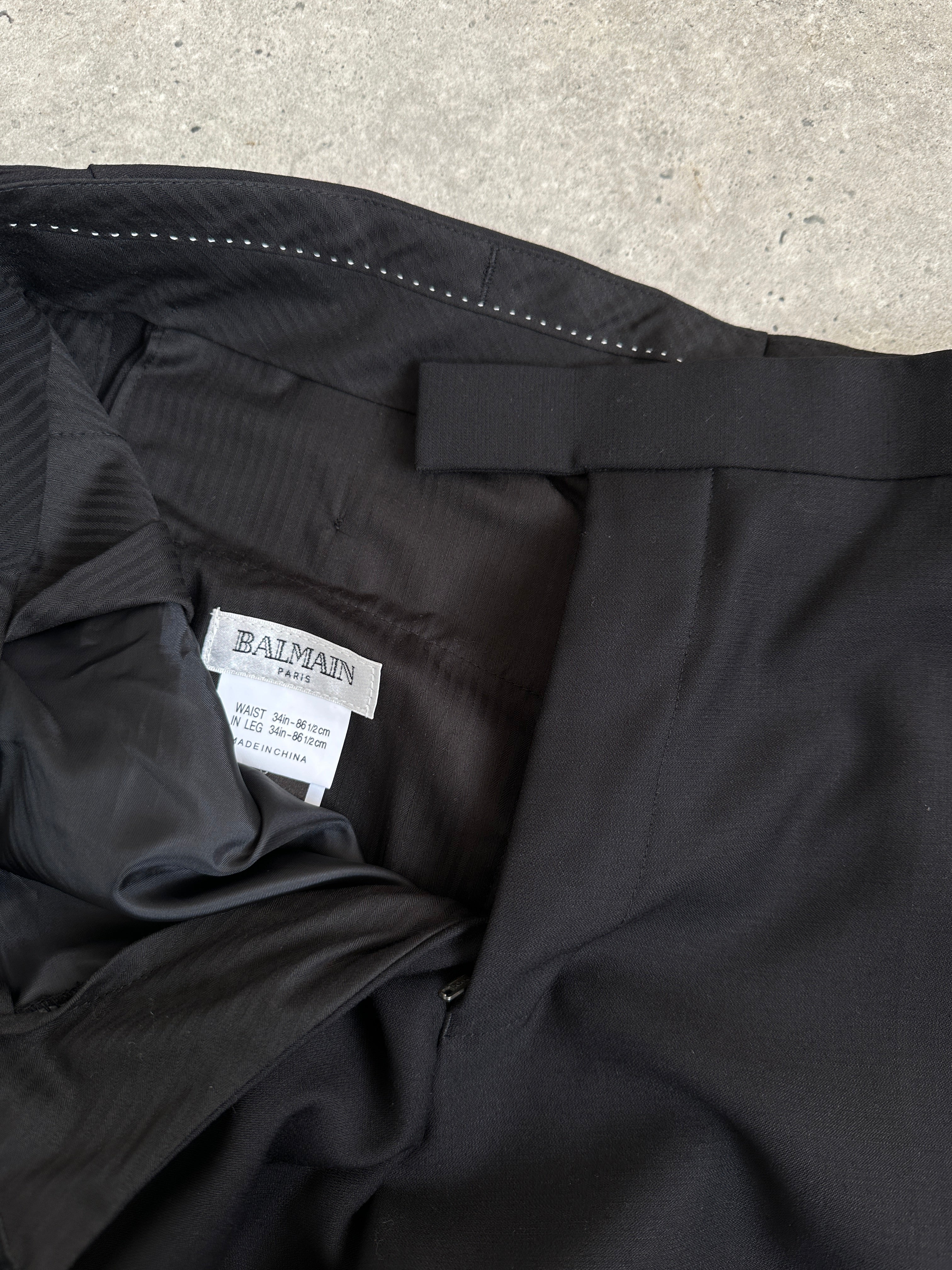 Balmain pure wool tailored tuxedo trousers in black with a sleek fit, size W30-32, featuring classic design and fine craftsmanship.