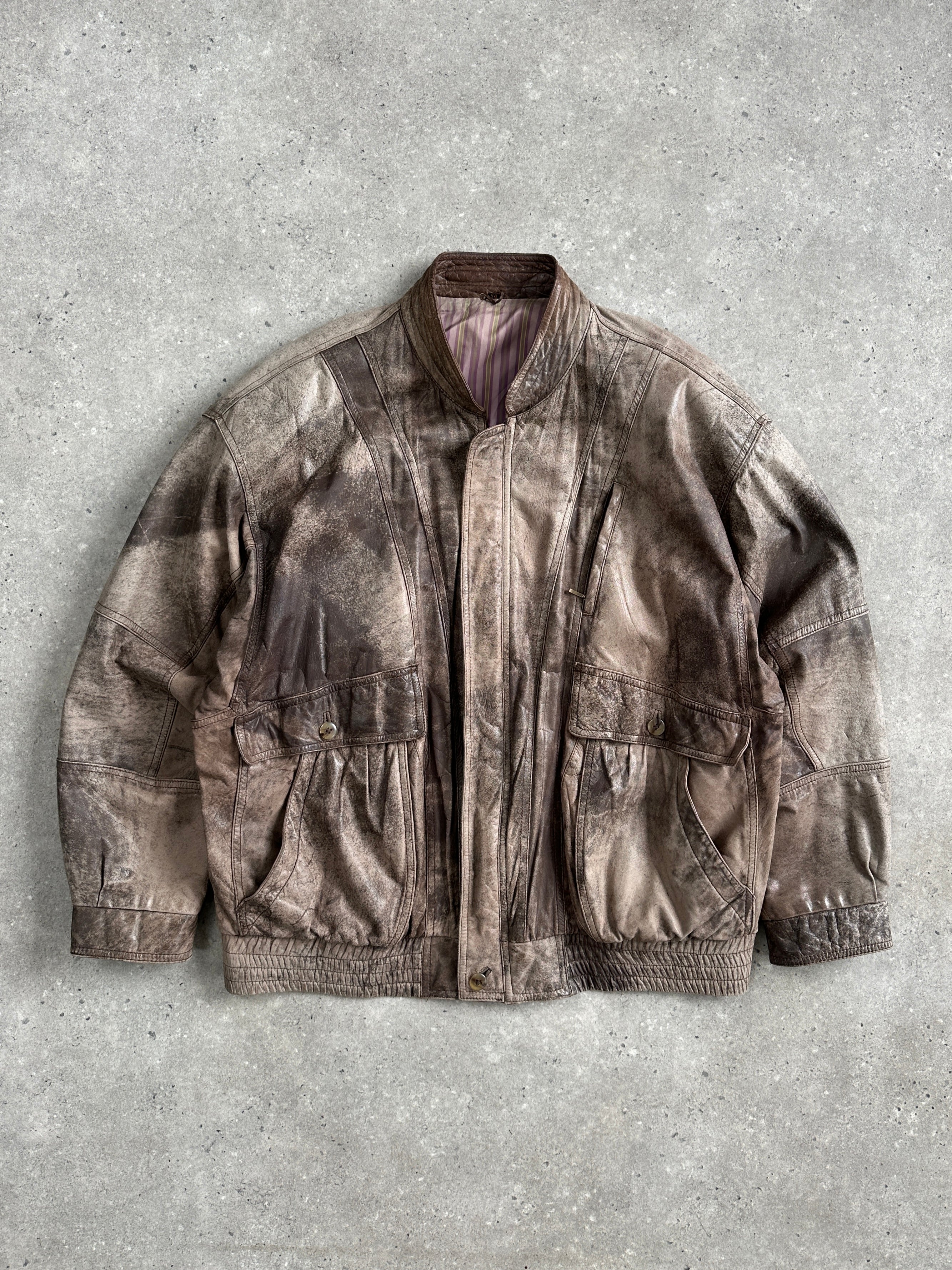 Vintage 1990s leather bomber jacket in XL, featuring classic design and authentic distressed leather, styled for a retro look.