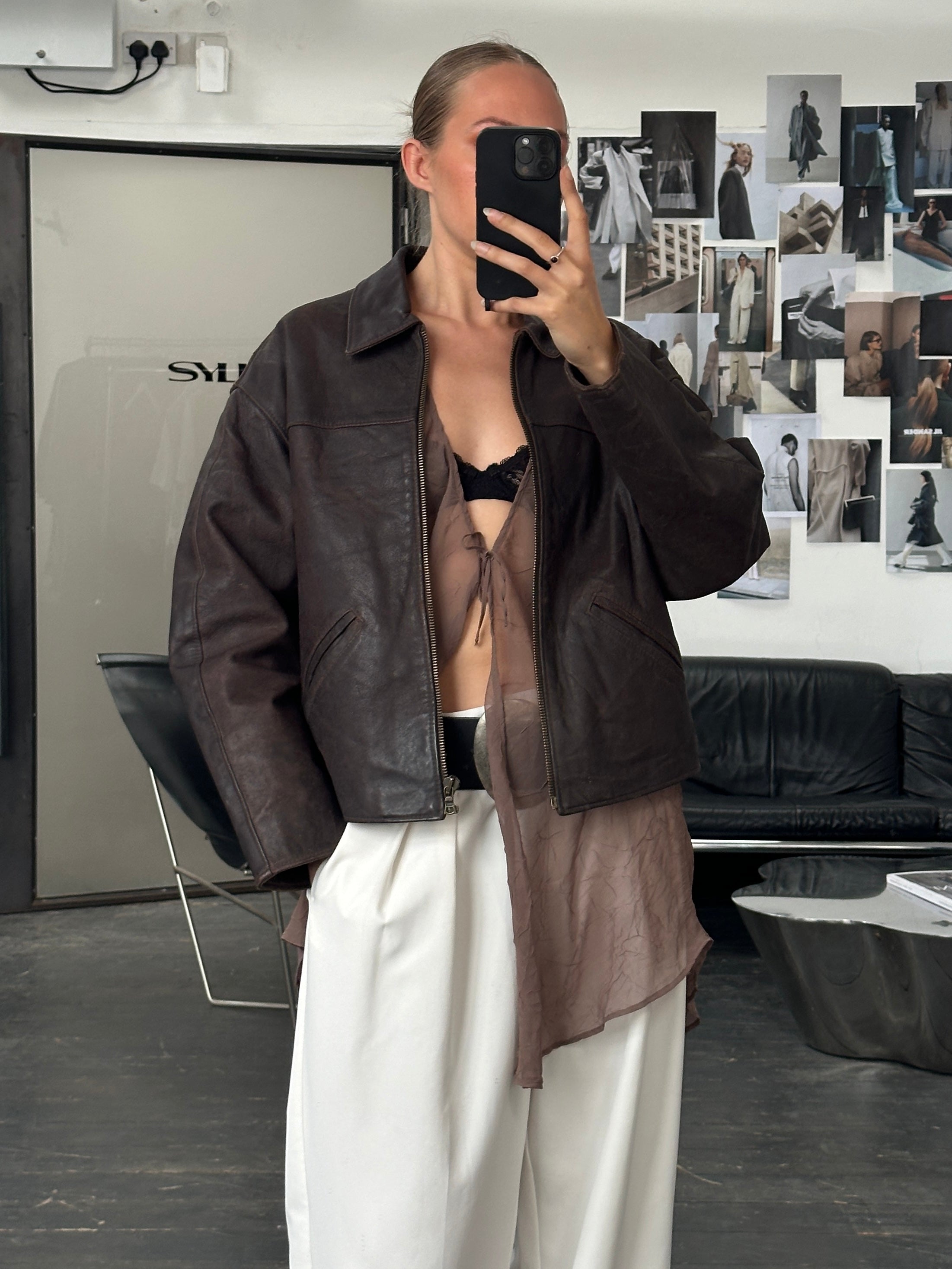 Vintage 1980s Cropped Leather Jacket, size L, with classic design and distressed leather, displayed on a hanger.