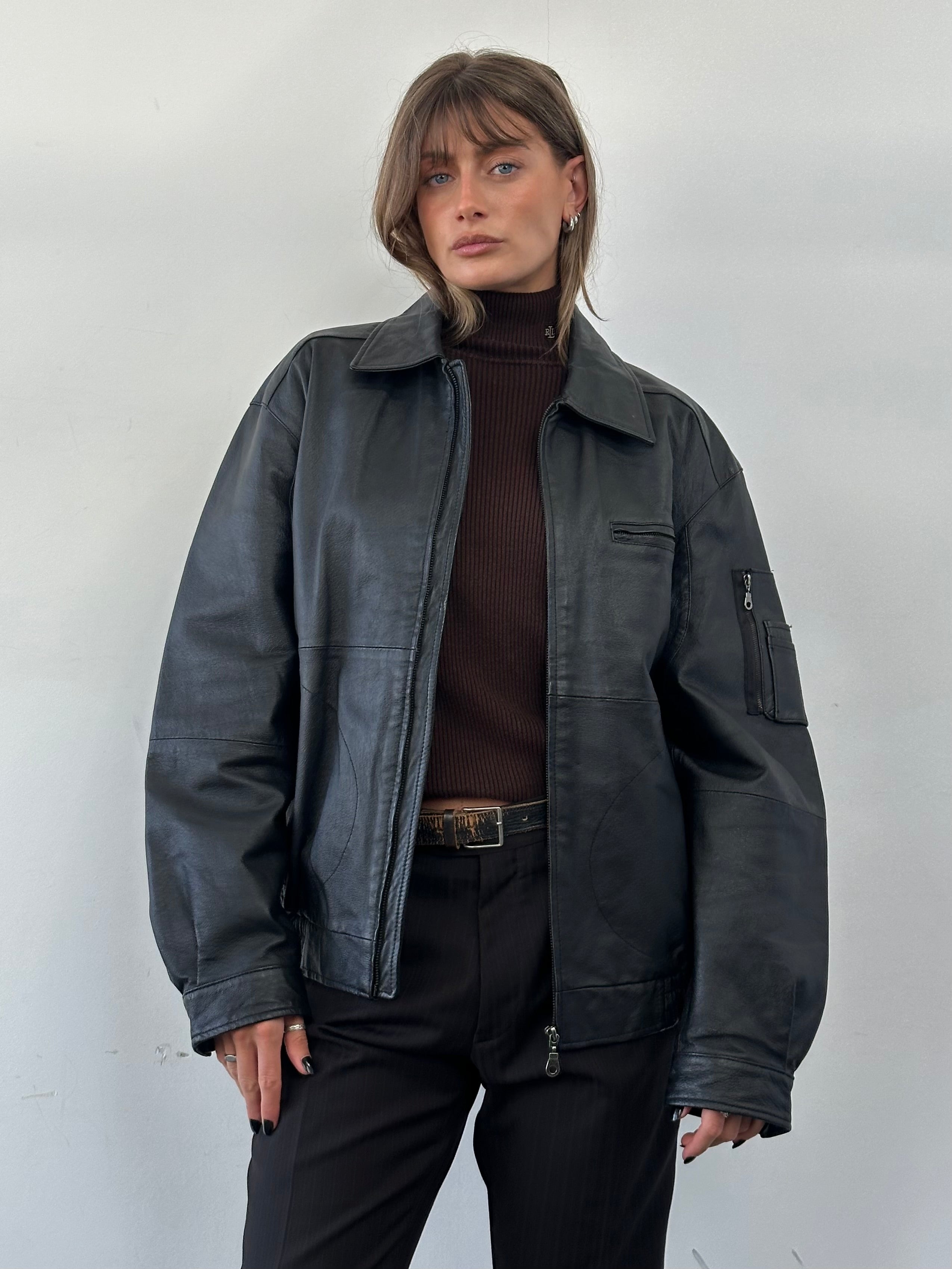 Vintage leather bomber jacket in XL size with classic design and distressed finish, featuring a front zipper and ribbed cuffs.