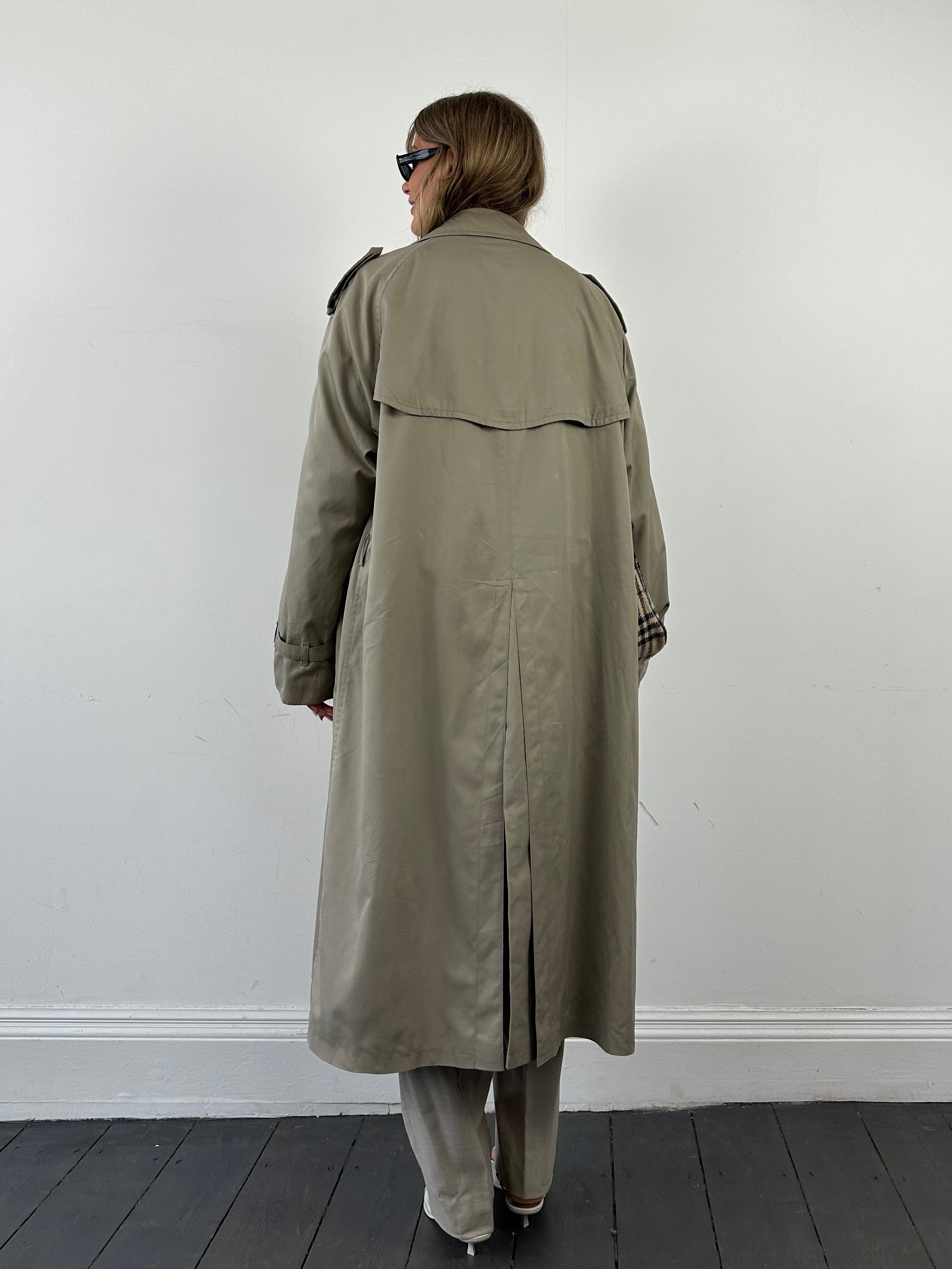 Vintage double-breasted trench coat in XXL size, classic beige color, shown on a hanger with detailed fabric texture.