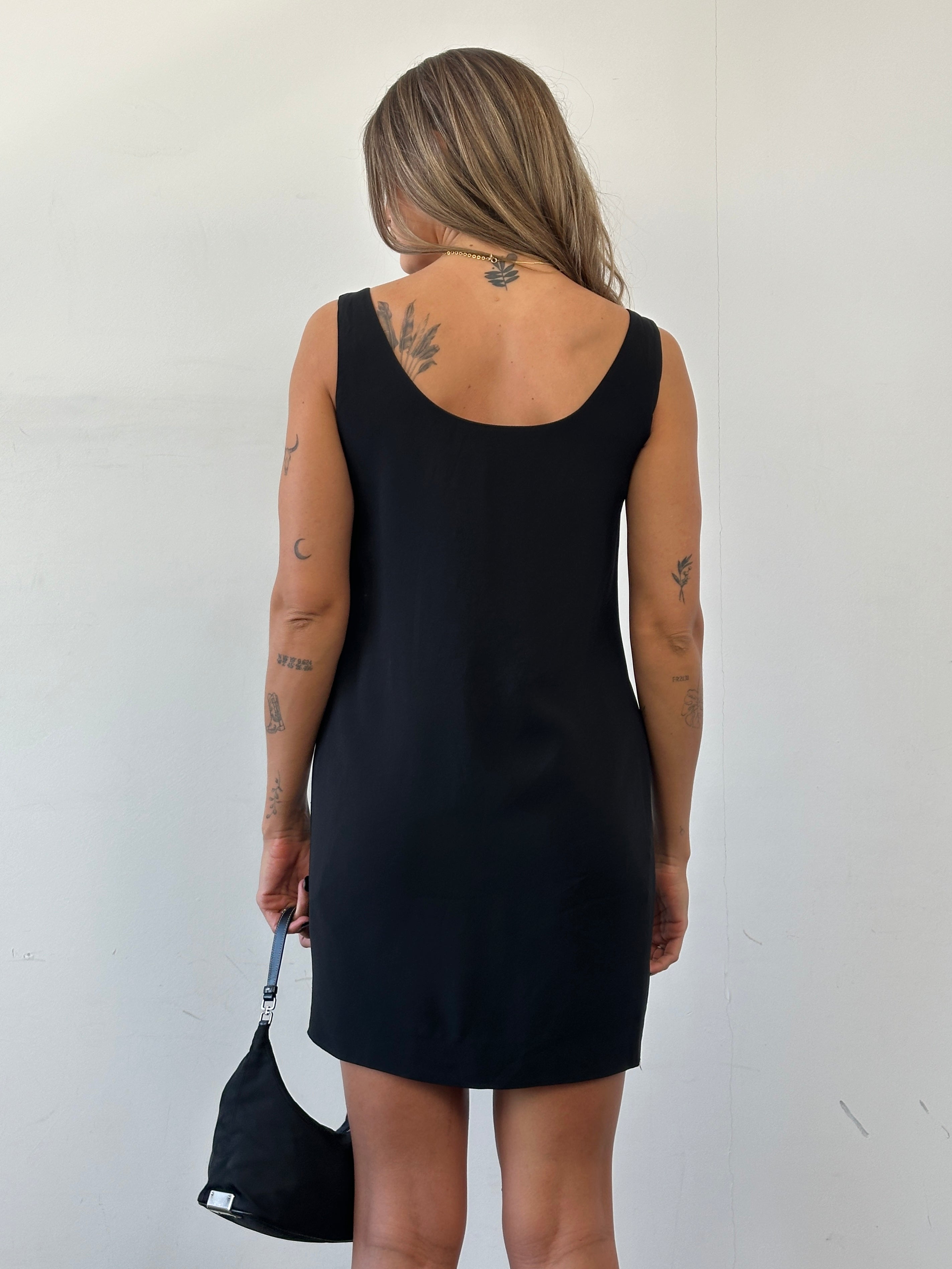 Moschino Couture fitted mini dress in black with bold graphic design, short sleeves, and a stylish, modern silhouette.