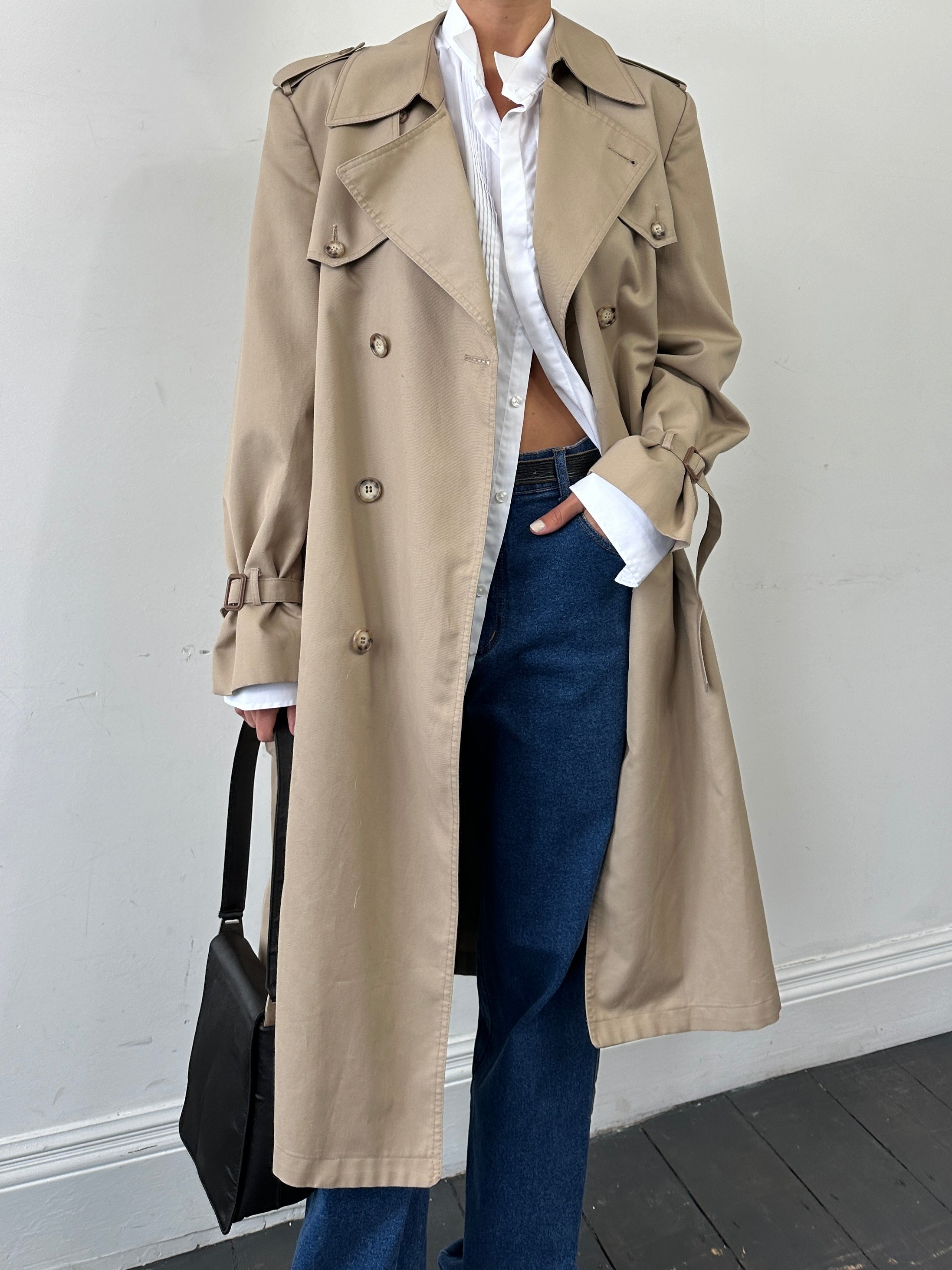 Christian Dior Monsieur double-breasted belted trench coat in beige, showing front view with classic collar and button details.