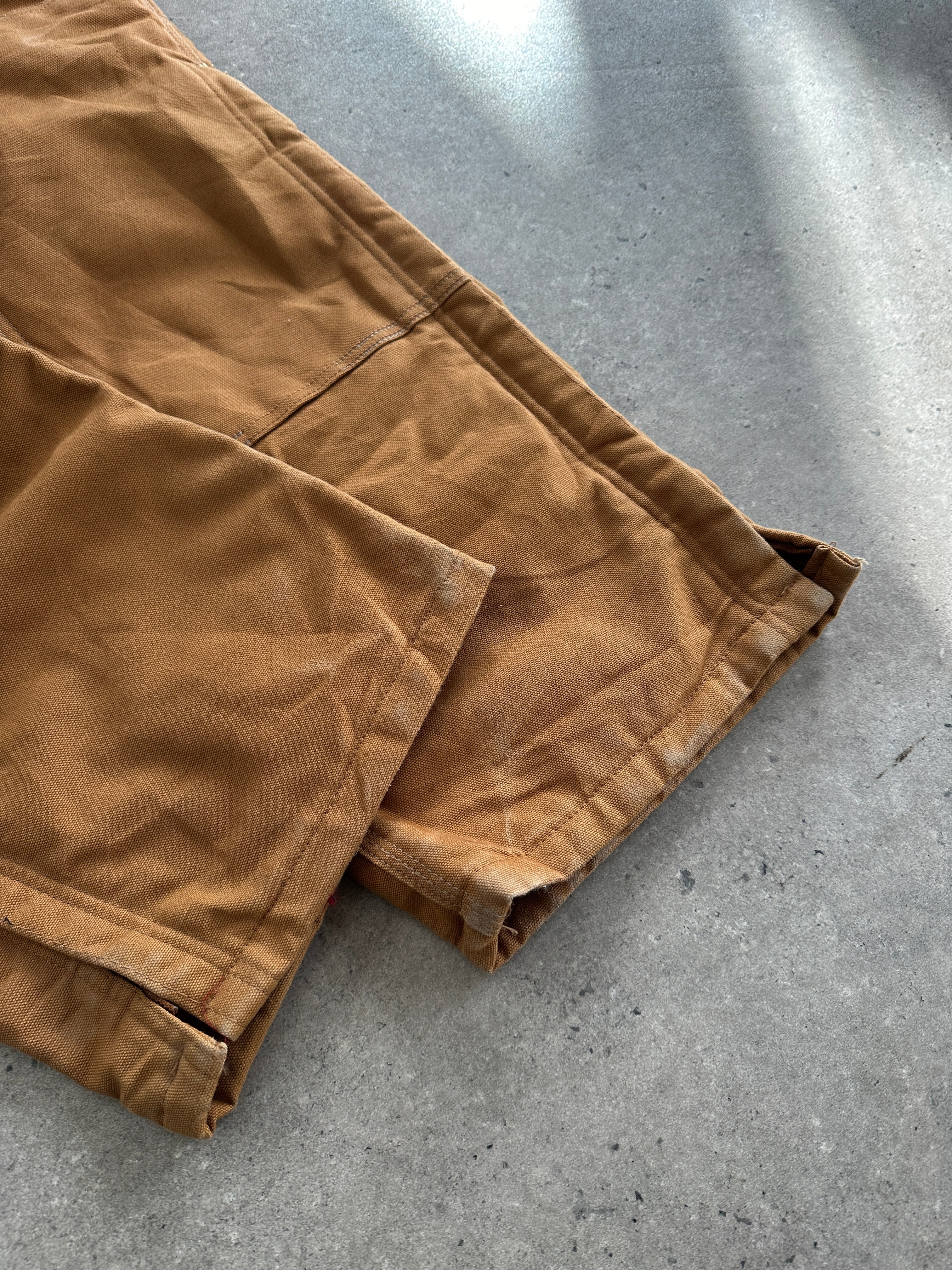 Carhartt pure cotton dungarees in size M, showing durable fabric and classic design with shoulder straps and front pockets.