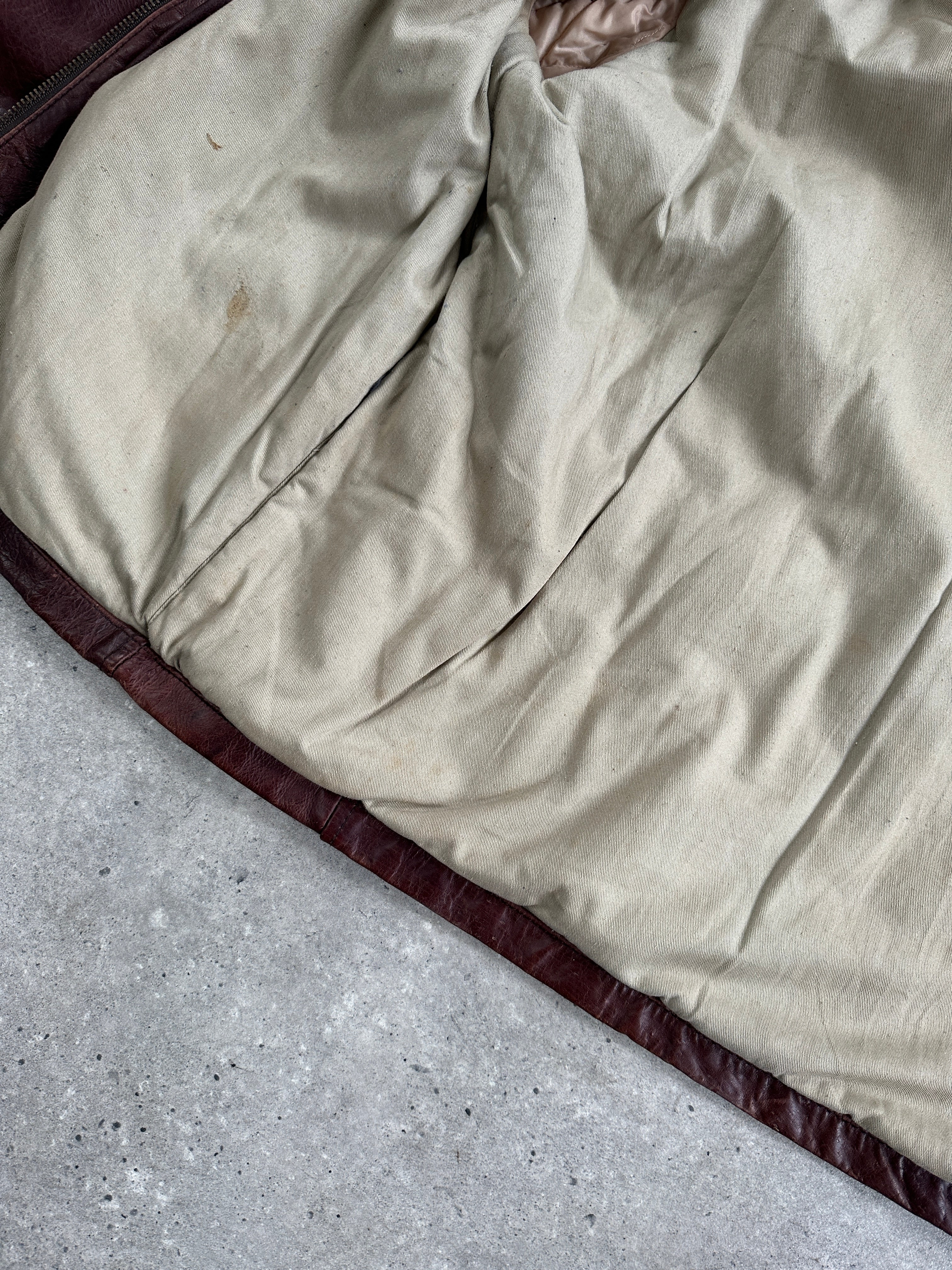 Vintage heavyweight leather jacket in XL, featuring aged leather and classic design, displayed on a hanger.