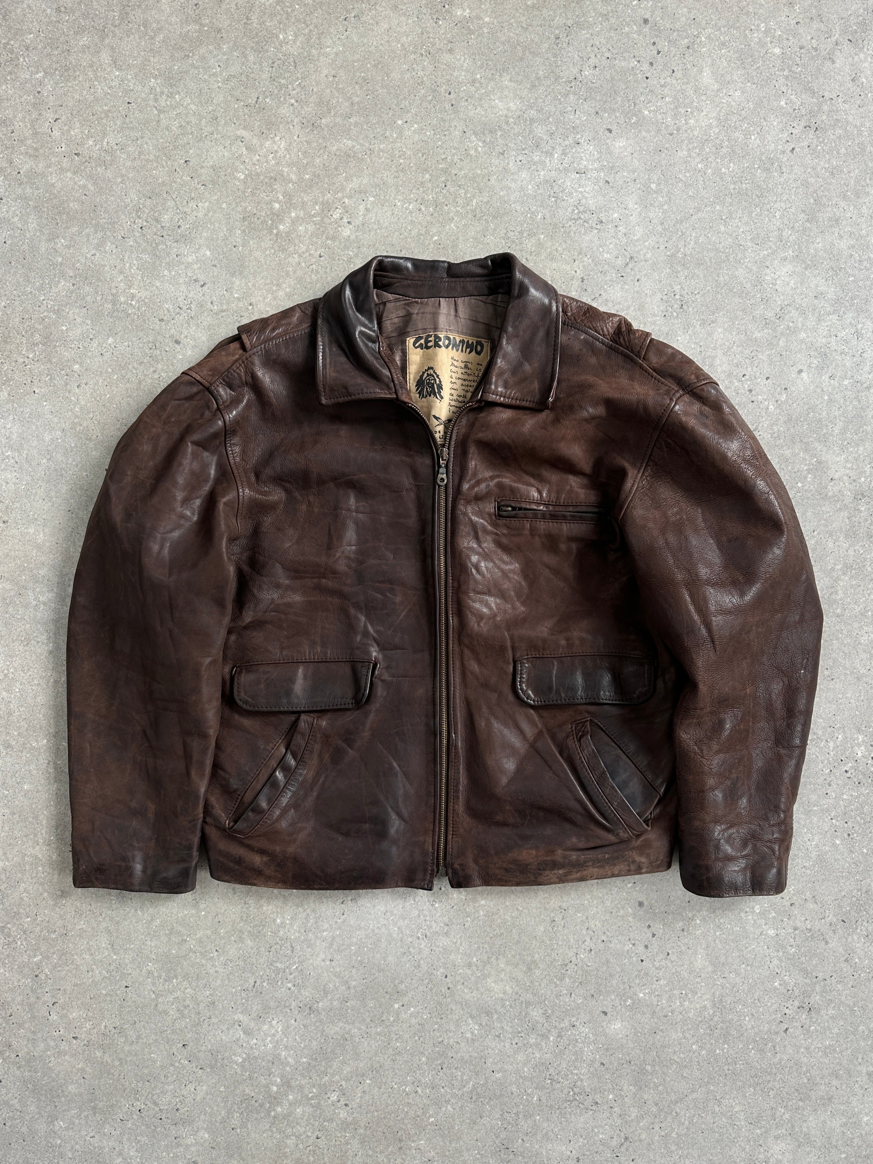 Vintage French leather jacket from the 1980s with a boxy fit, aged leather, and classic design in size large.