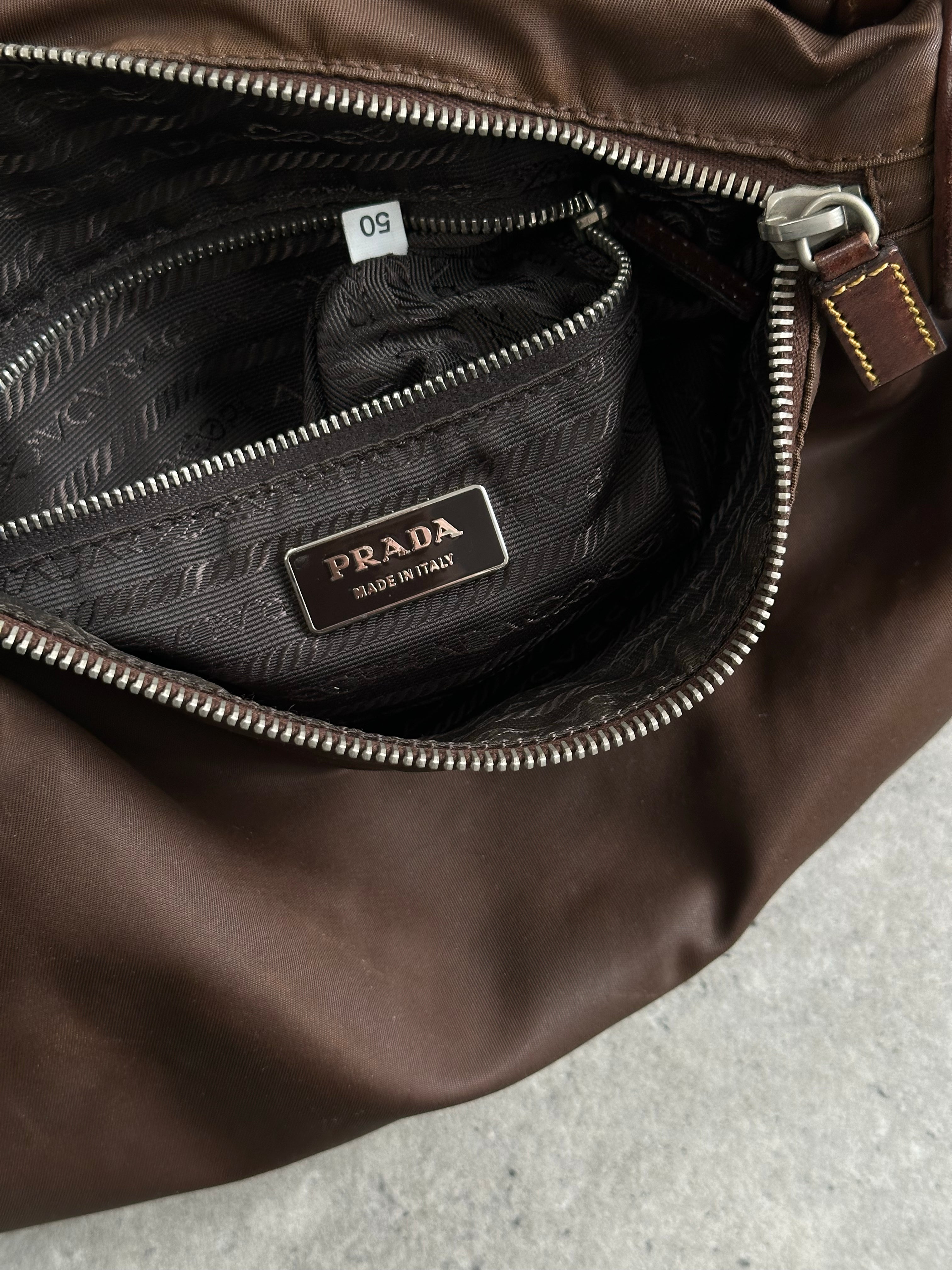 Prada 1990s nylon crossbody bag with adjustable strap and zip closure, featuring a sleek, minimalist design.