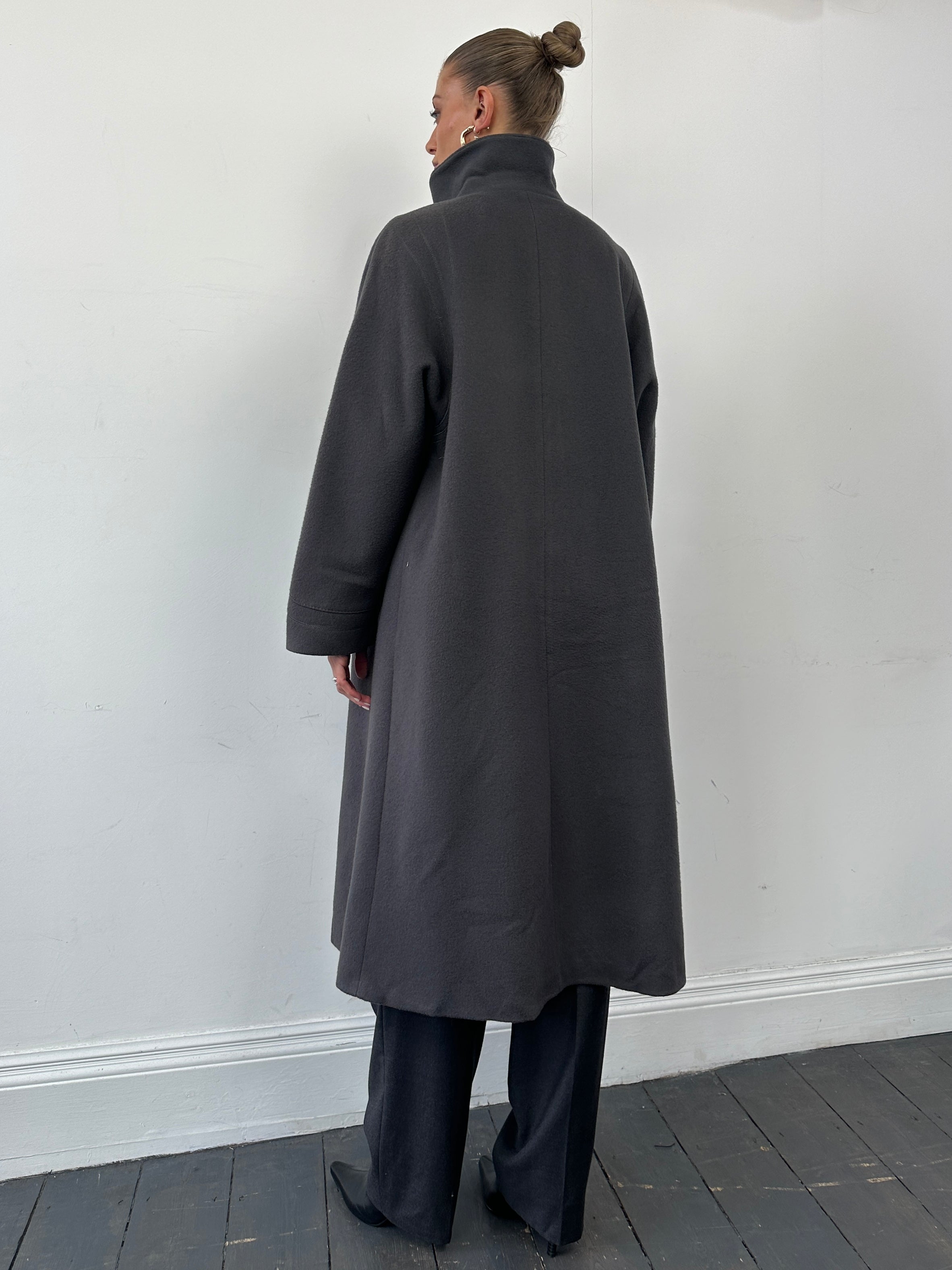 Vintage brand wool single-breasted coat in size M, showcasing classic design with a tailored fit and textured fabric.