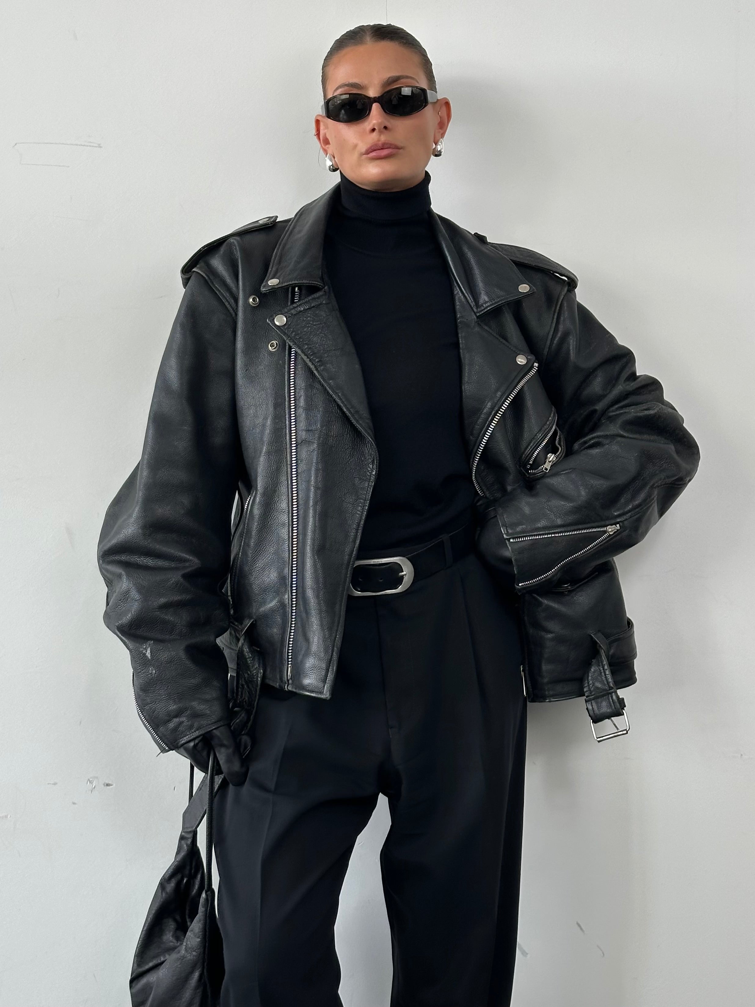 Vintage leather biker jacket in XL size, featuring classic design with metal hardware and distressed finish.