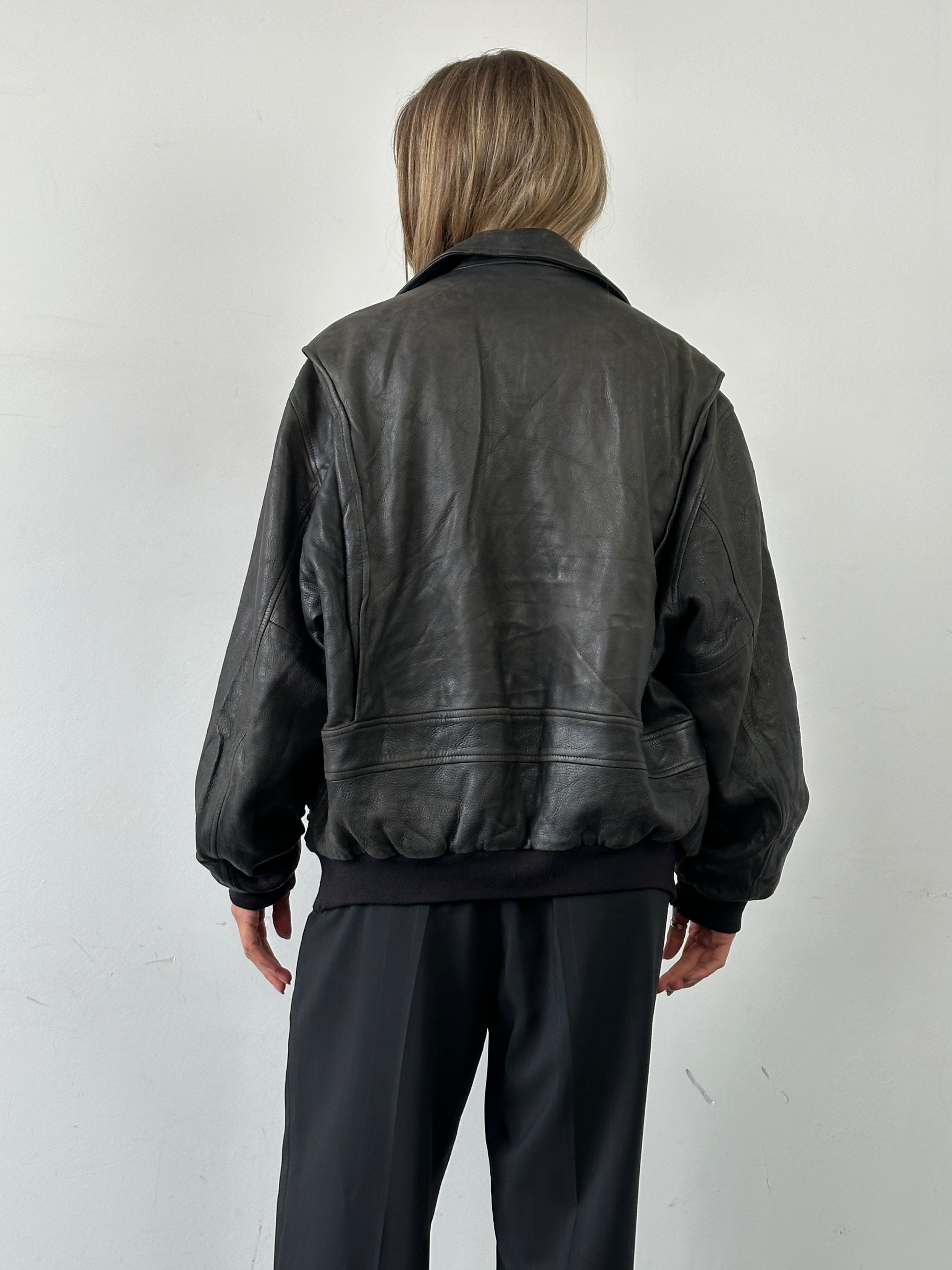 Vintage Italian aged leather bomber jacket in XL, showcasing distressed leather and classic bomber style.