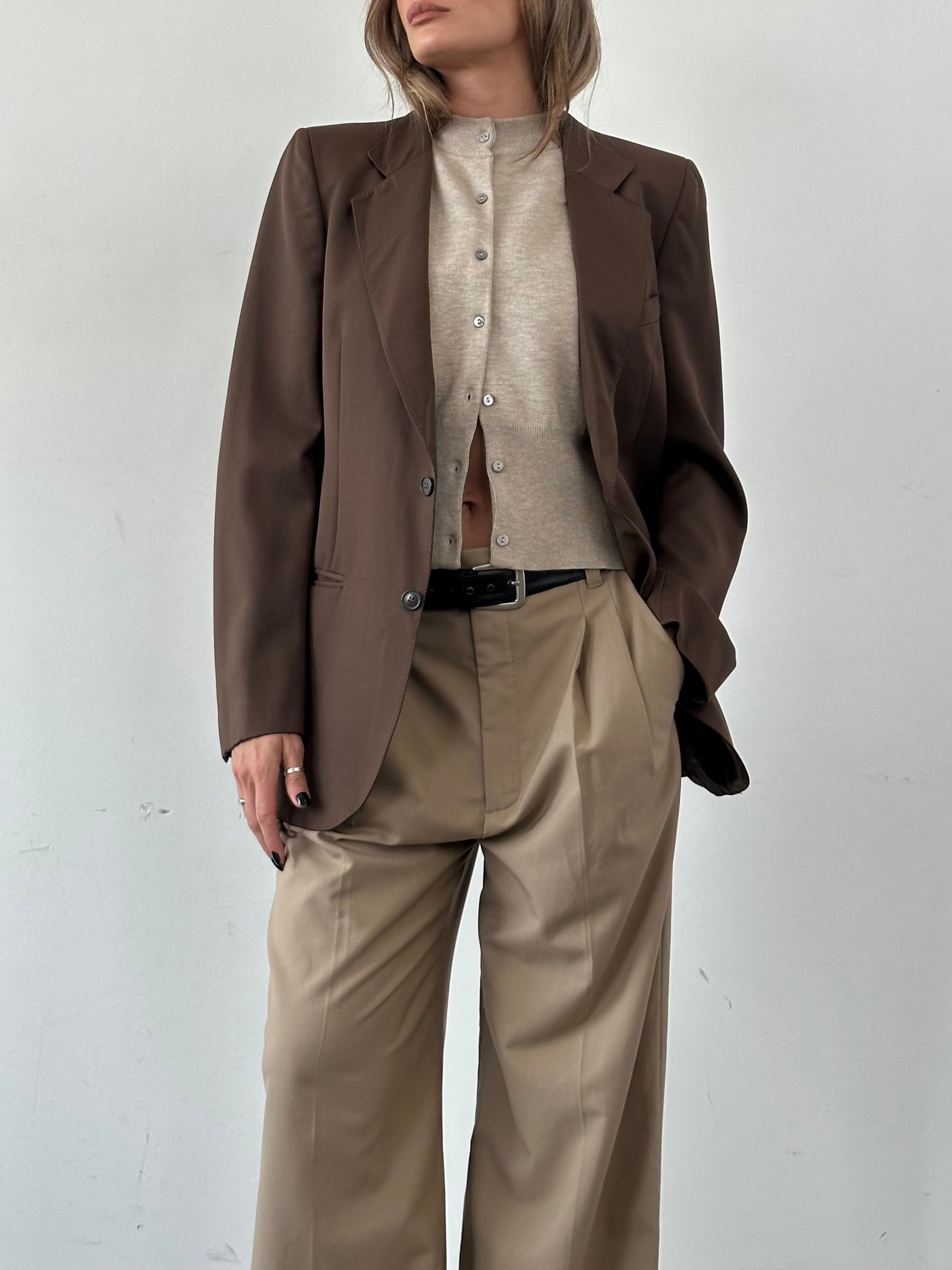 Vintage Italian vintage pure wool single-breasted blazer in size S/M, shown on a hanger with classic tailored details.