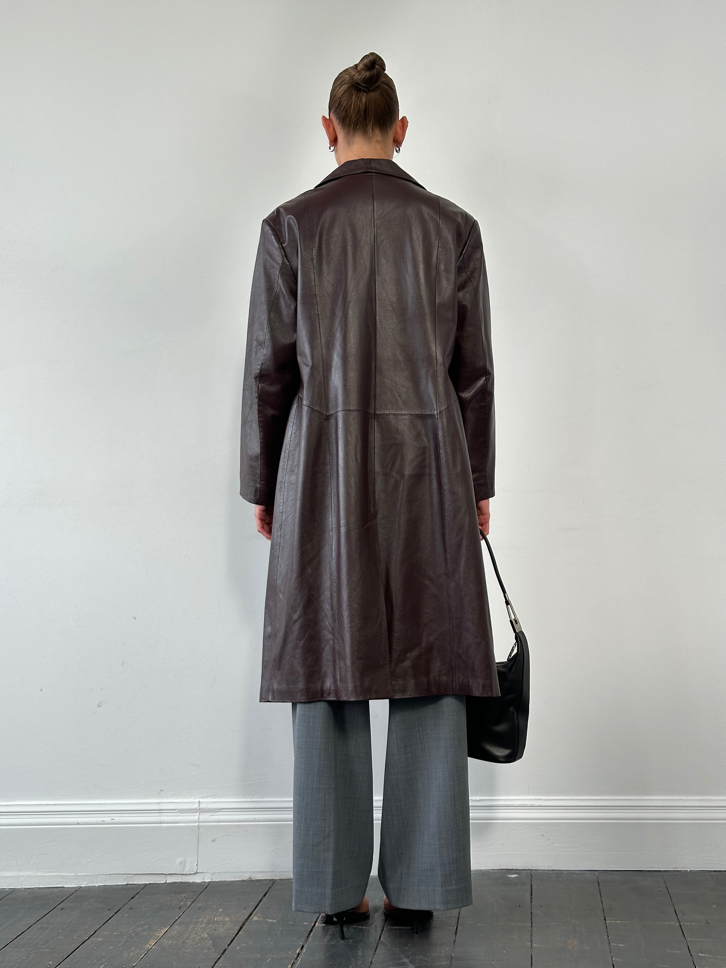 Vintage leather trench coat jacket in size large with classic design and aged leather texture, stylish outerwear for casual or formal wear.