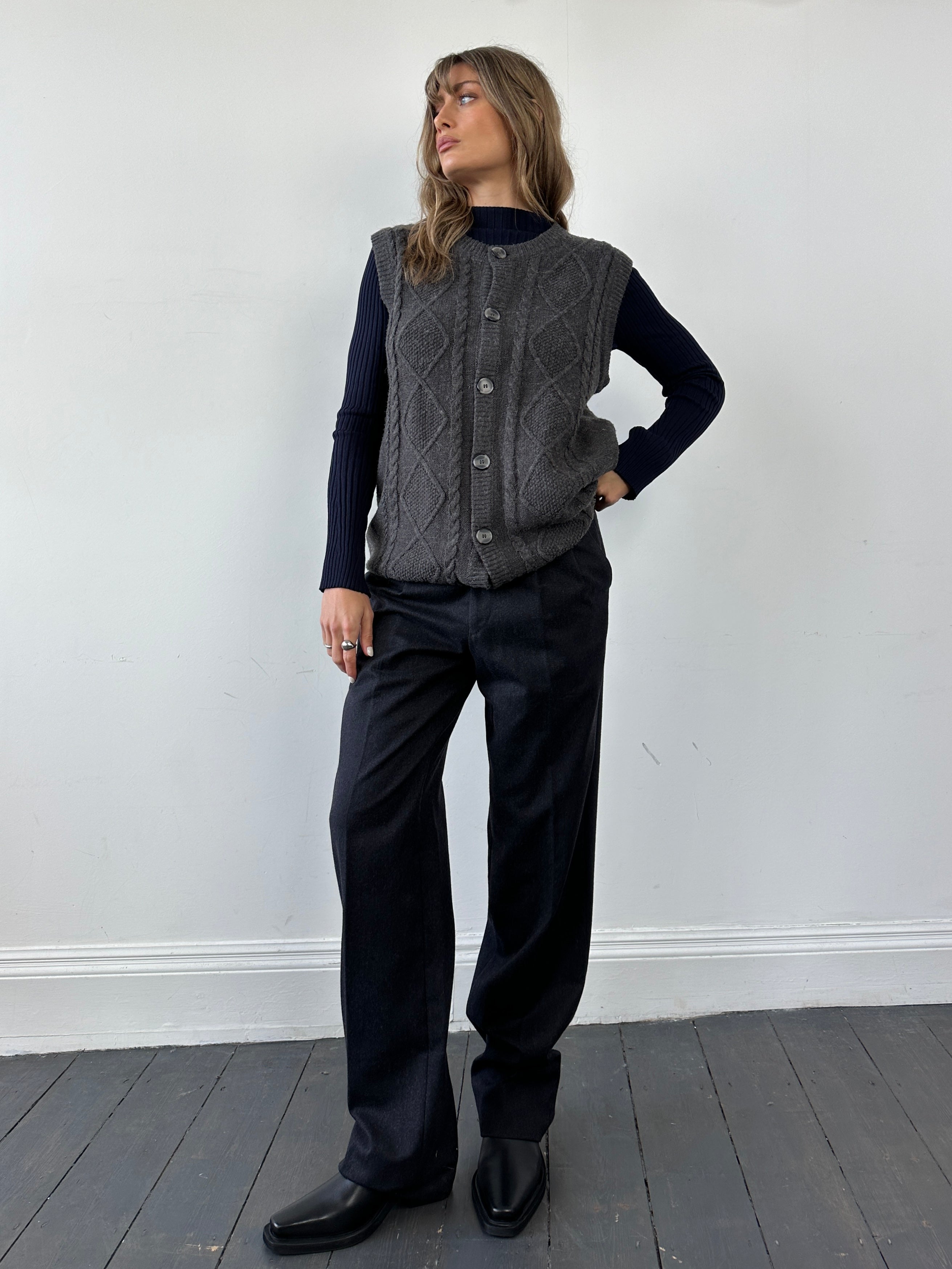 Vintage brand vintage cable knit sleeveless cardigan in size L/XL, showing its textured knit pattern and classic design.