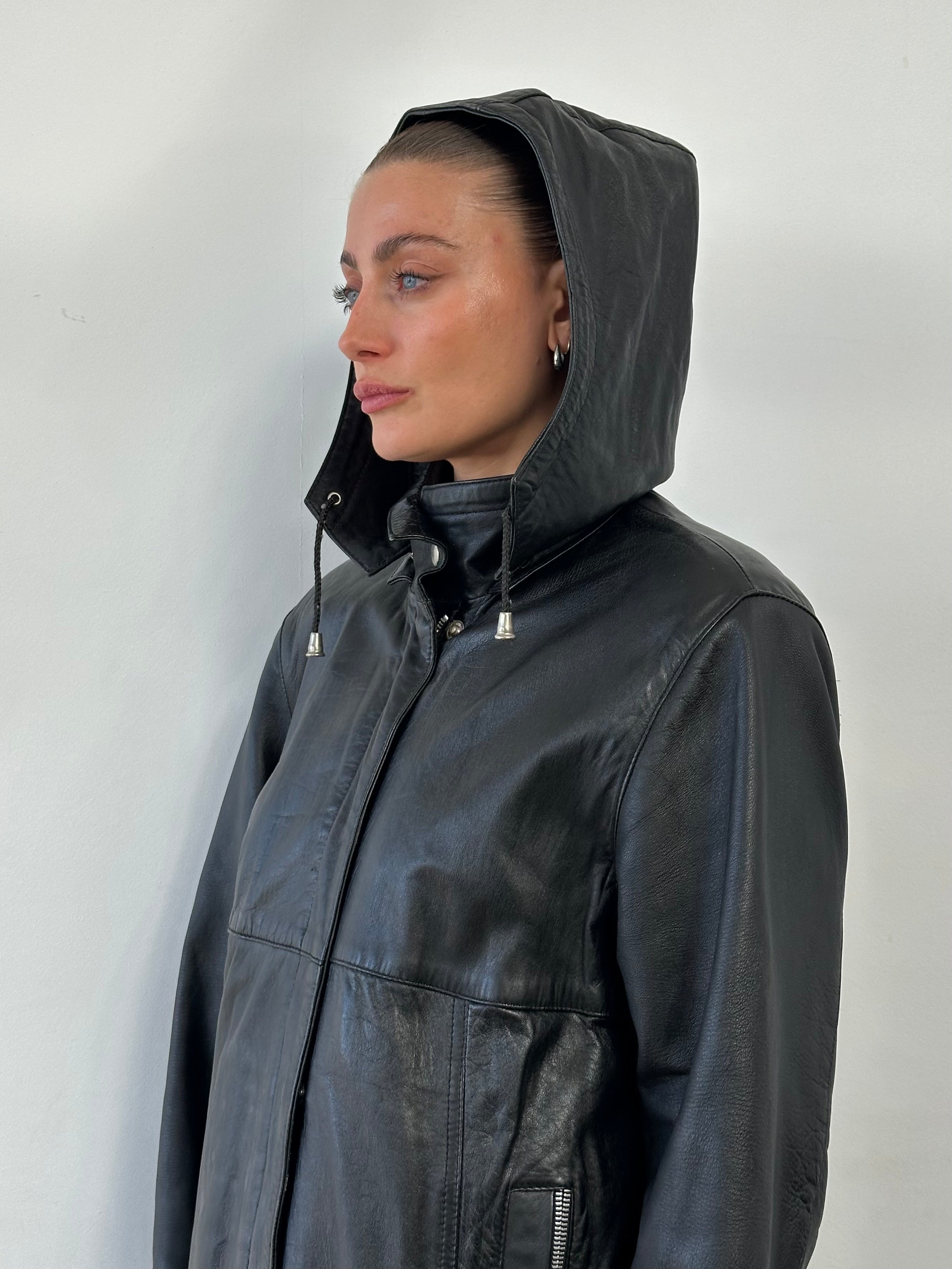 Vintage high neck leather jacket with removable hood, in black, featuring classic design and zipper details.