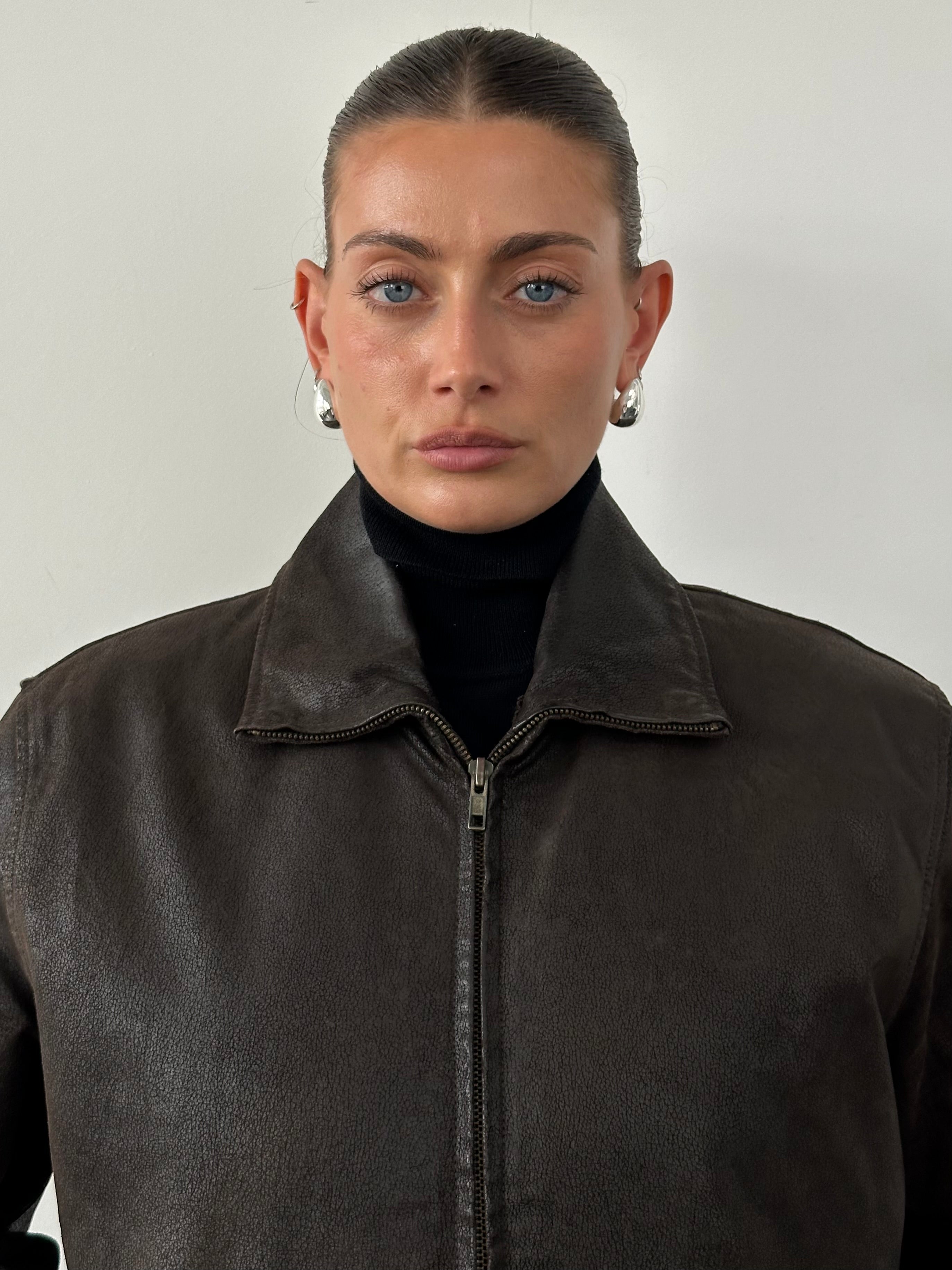 Vintage fur-lined leather jacket in size M/L, featuring classic design with warm fur interior and durable leather exterior.