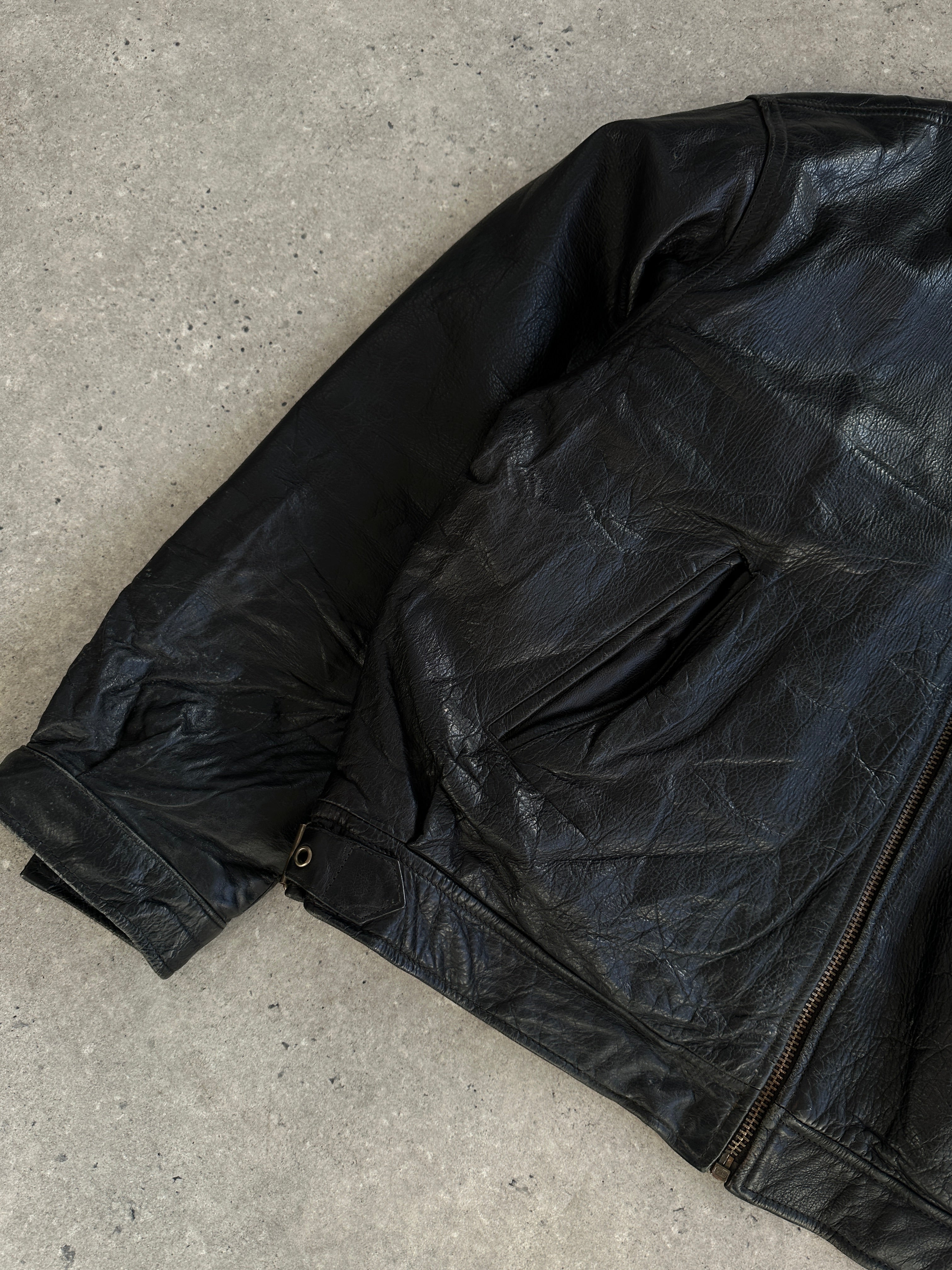 Vintage leather jacket in XL size with classic design, featuring a rugged brown leather exterior and stylish details.
