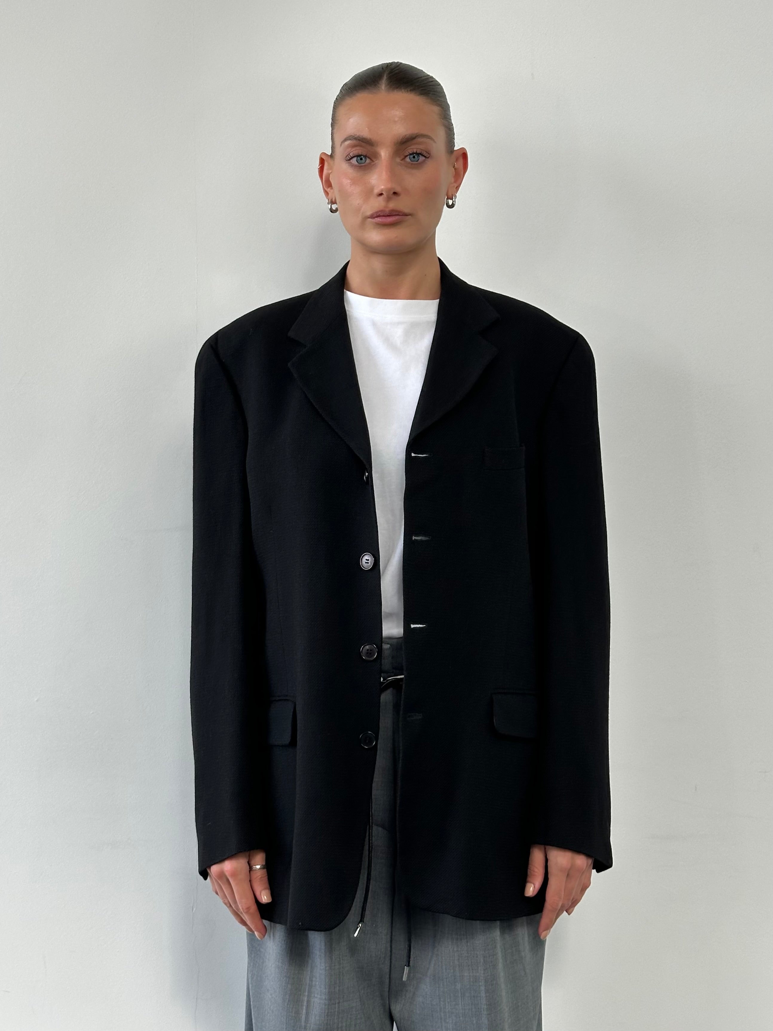 Yves Saint Laurent 1990s wool woven single-breasted blazer in size 42R/L, tailored fit with classic lapel and structured design.
