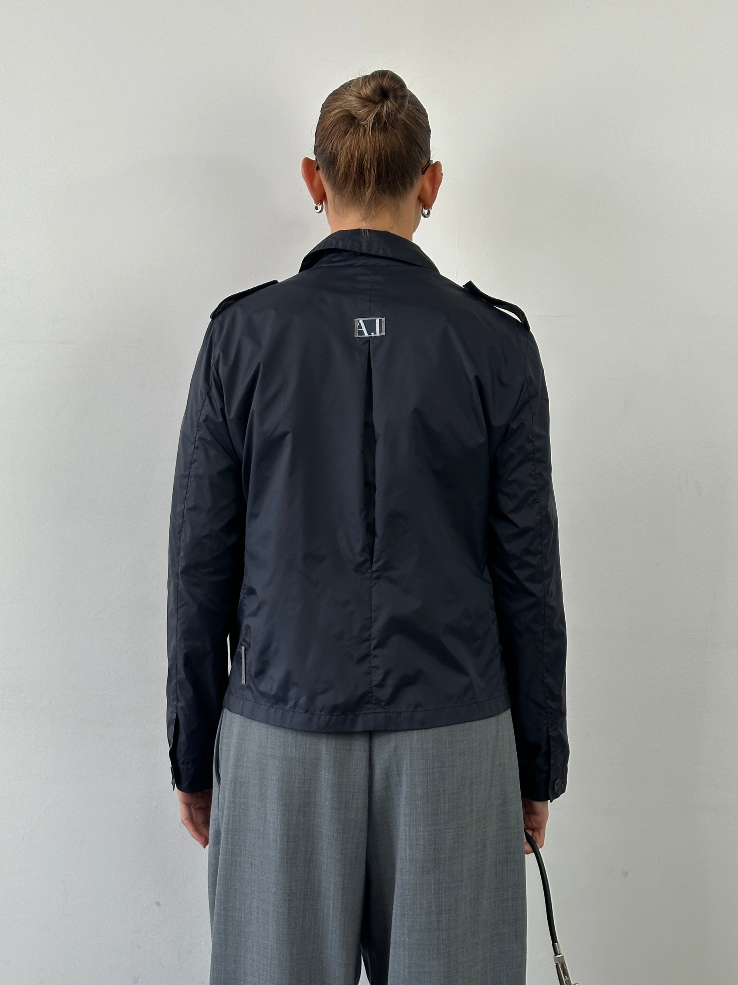 Armani Jeans 1990s showerproof nylon lightweight logo jacket in size S/M, featuring a sleek design and branded logo detail.