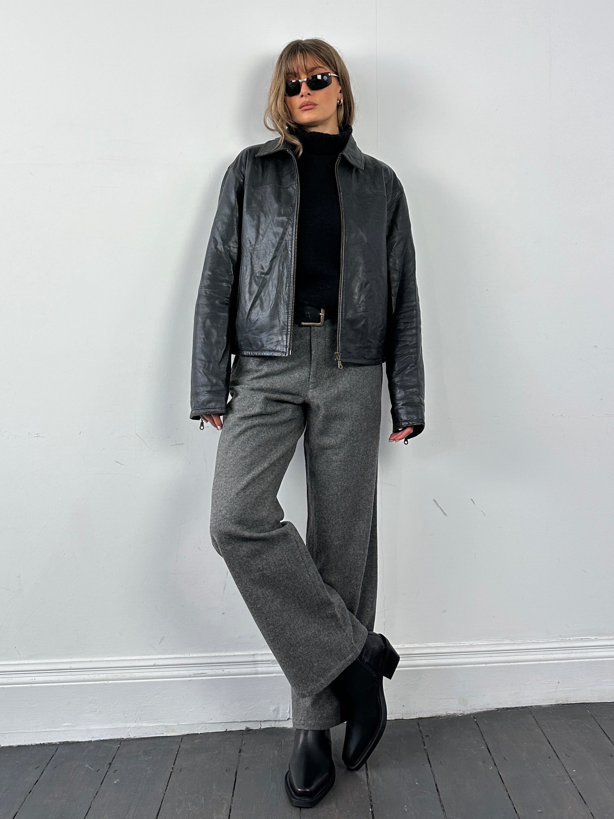 Conbipel leather jacket in size M/L, featuring a stylish black leather design with classic collar and zipper details.