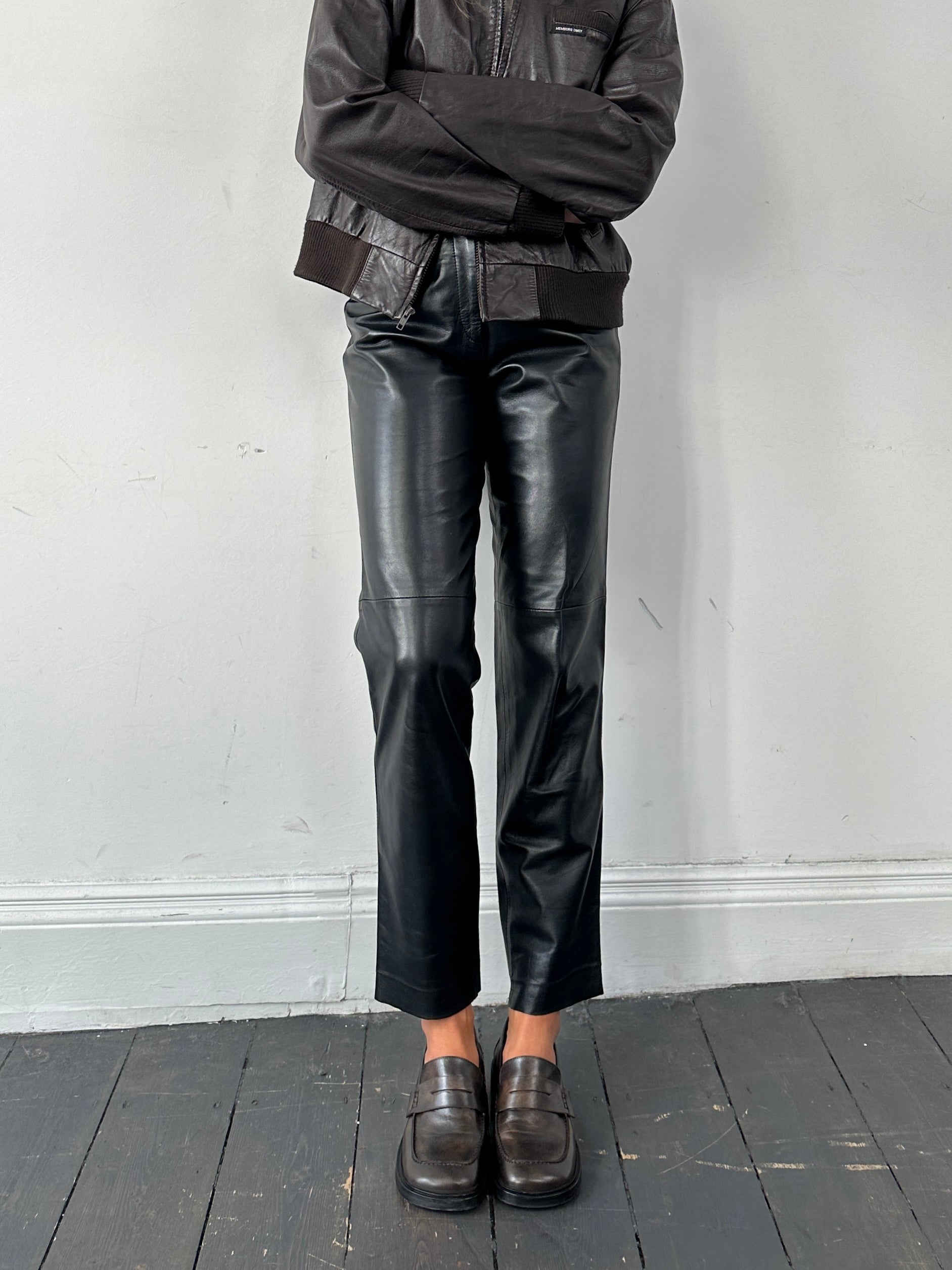 Vintage high waisted smooth leather trousers in size W26, featuring a sleek, fitted design and classic style.
