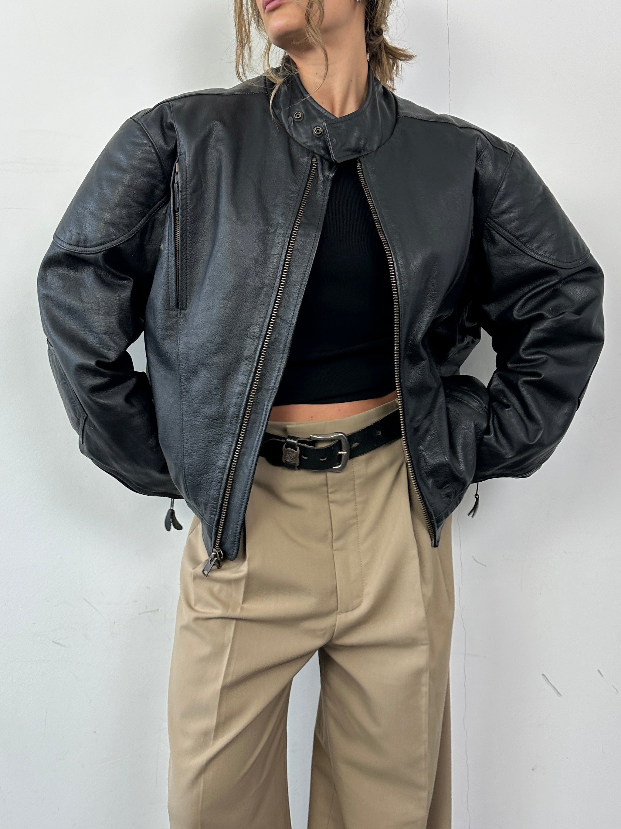 Vintage leather motorcycle jacket in XL, featuring classic design and rugged texture, ideal for motorcycle enthusiasts.