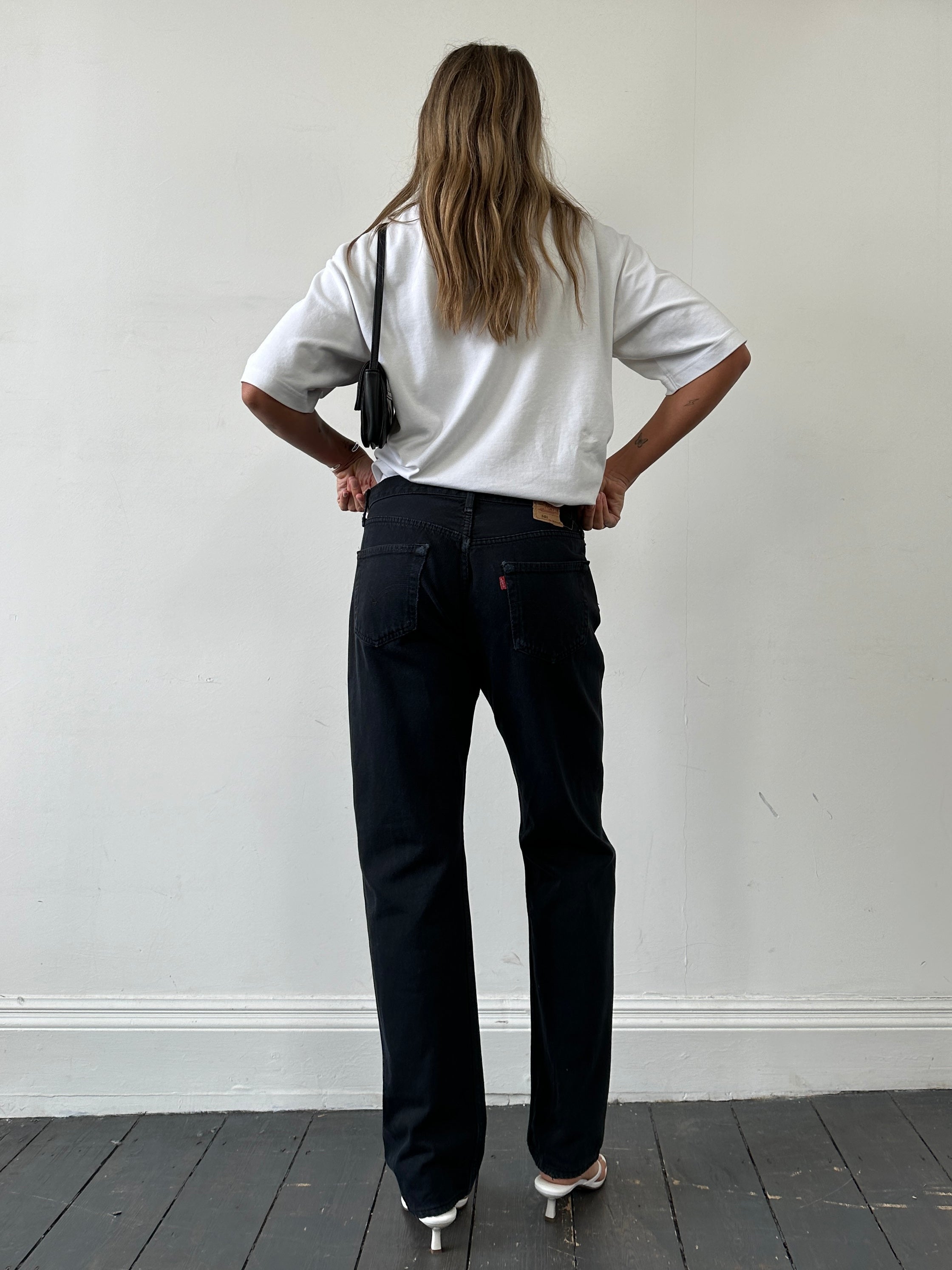 Levi’s 501 straight leg high-waisted denim jeans in W32, showing classic blue wash and button fly detail.