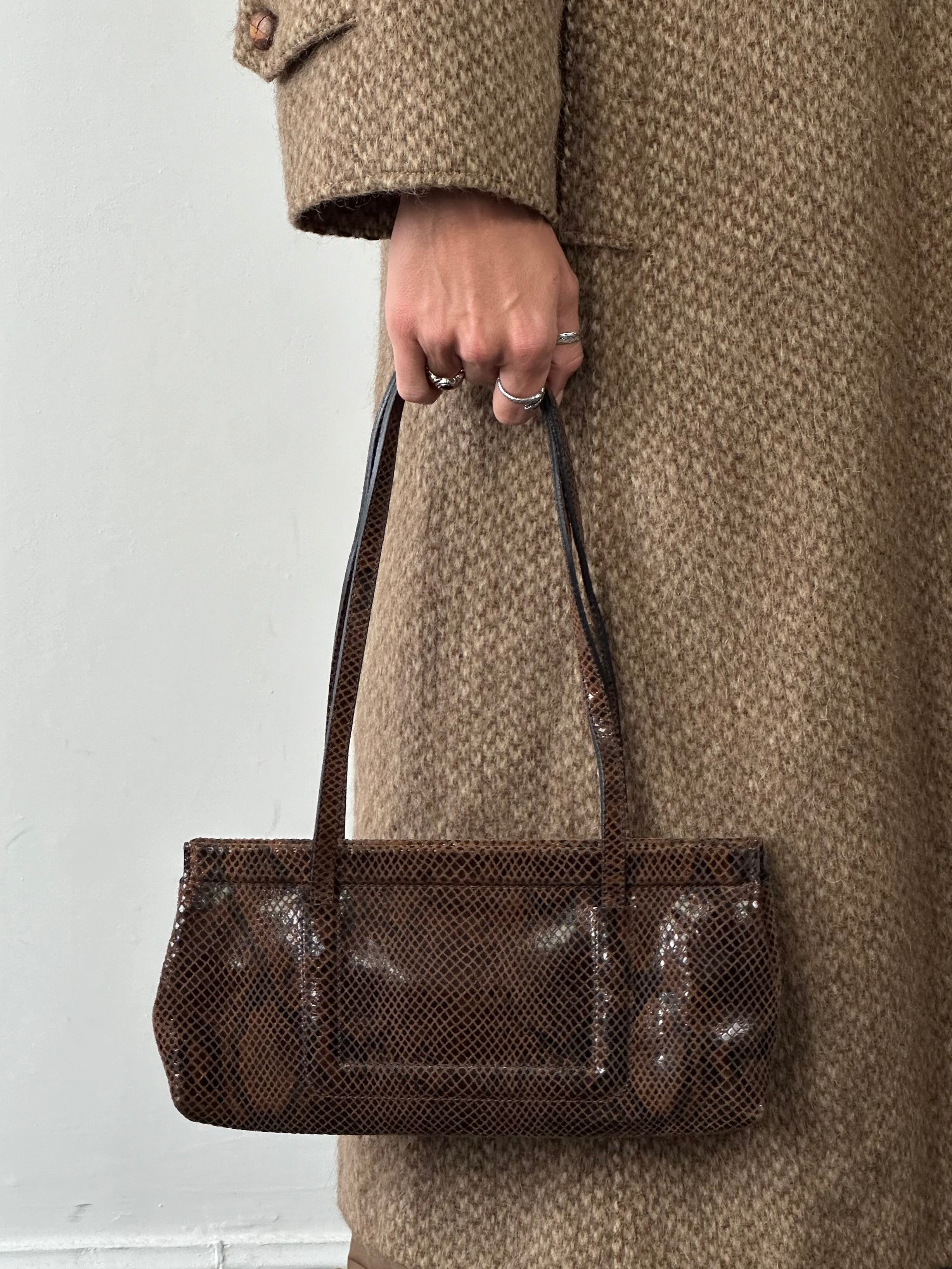 Emporio Armani snakeskin handbag featuring a sleek design, textured snakeskin pattern, and elegant shape for stylish accessorizing.