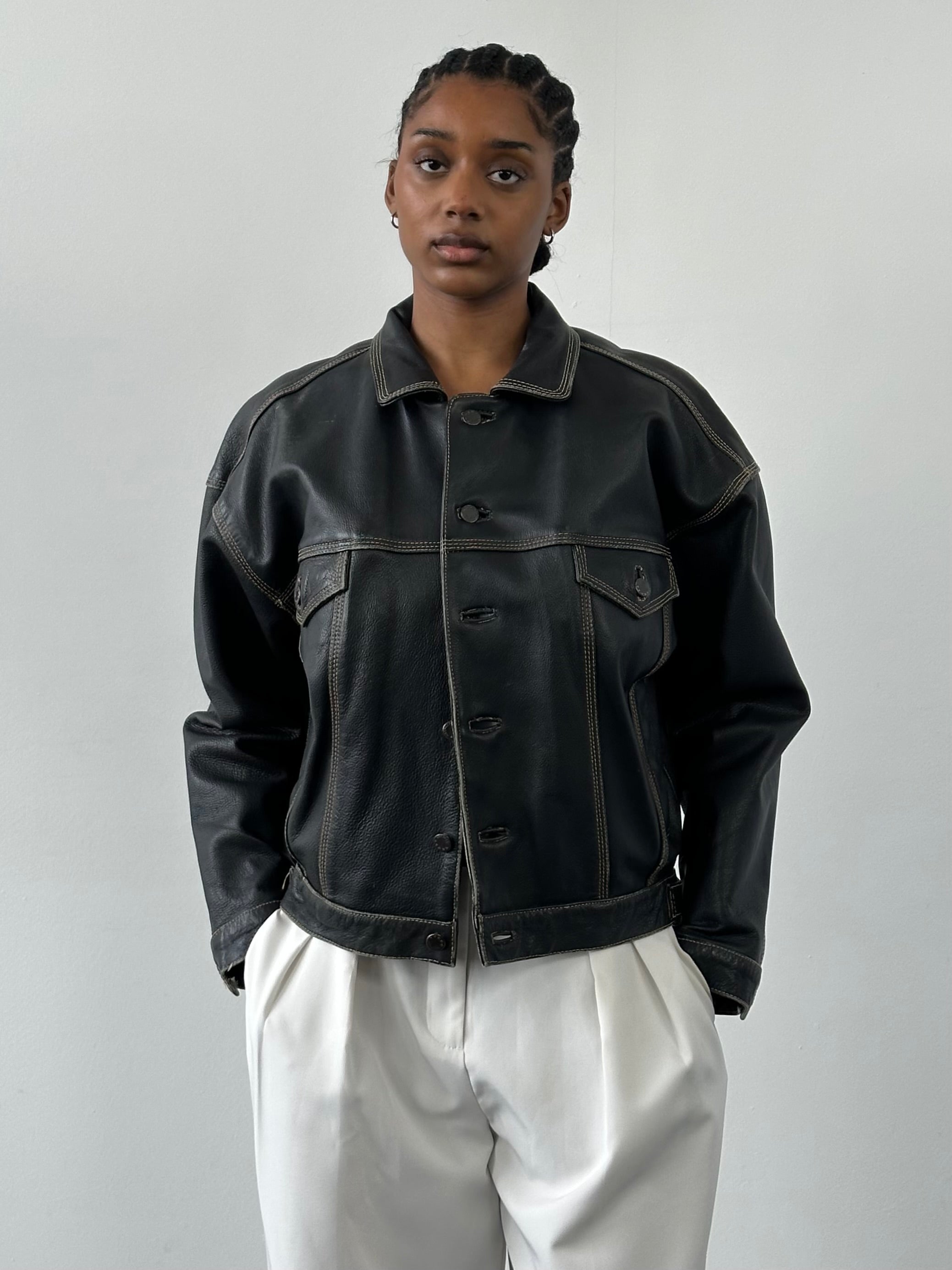 Vintage 1990s leather boxy jacket in black with cropped fit, featuring a rugged, classic design perfect for retro style.