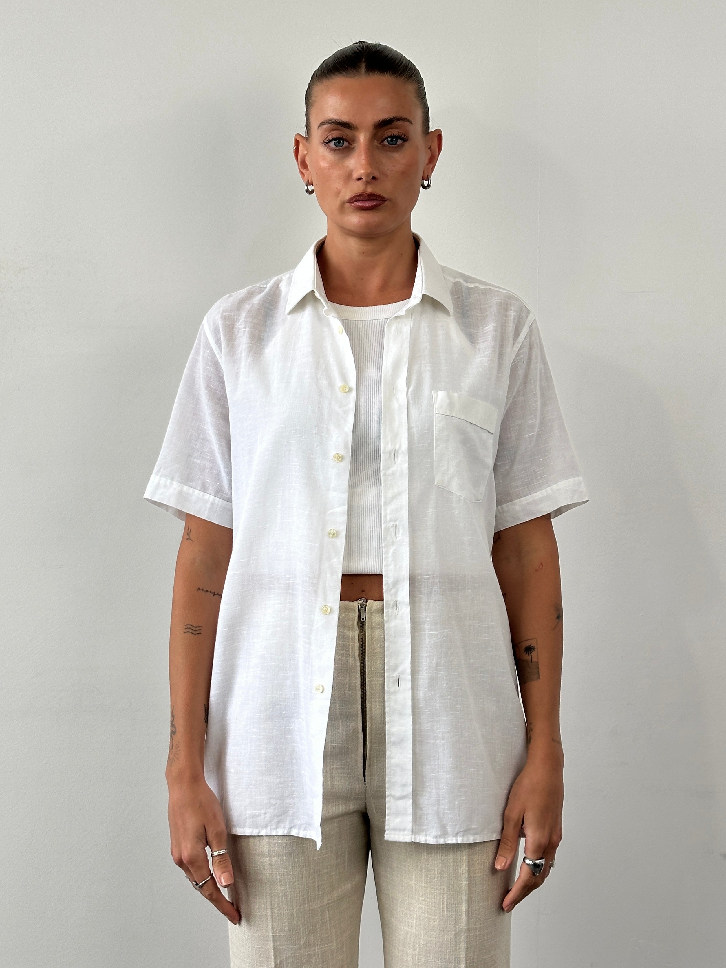 Vintage sheer short sleeve shirt in size M/L, lightweight and stylish with a classic vintage design, shown on a hanger.