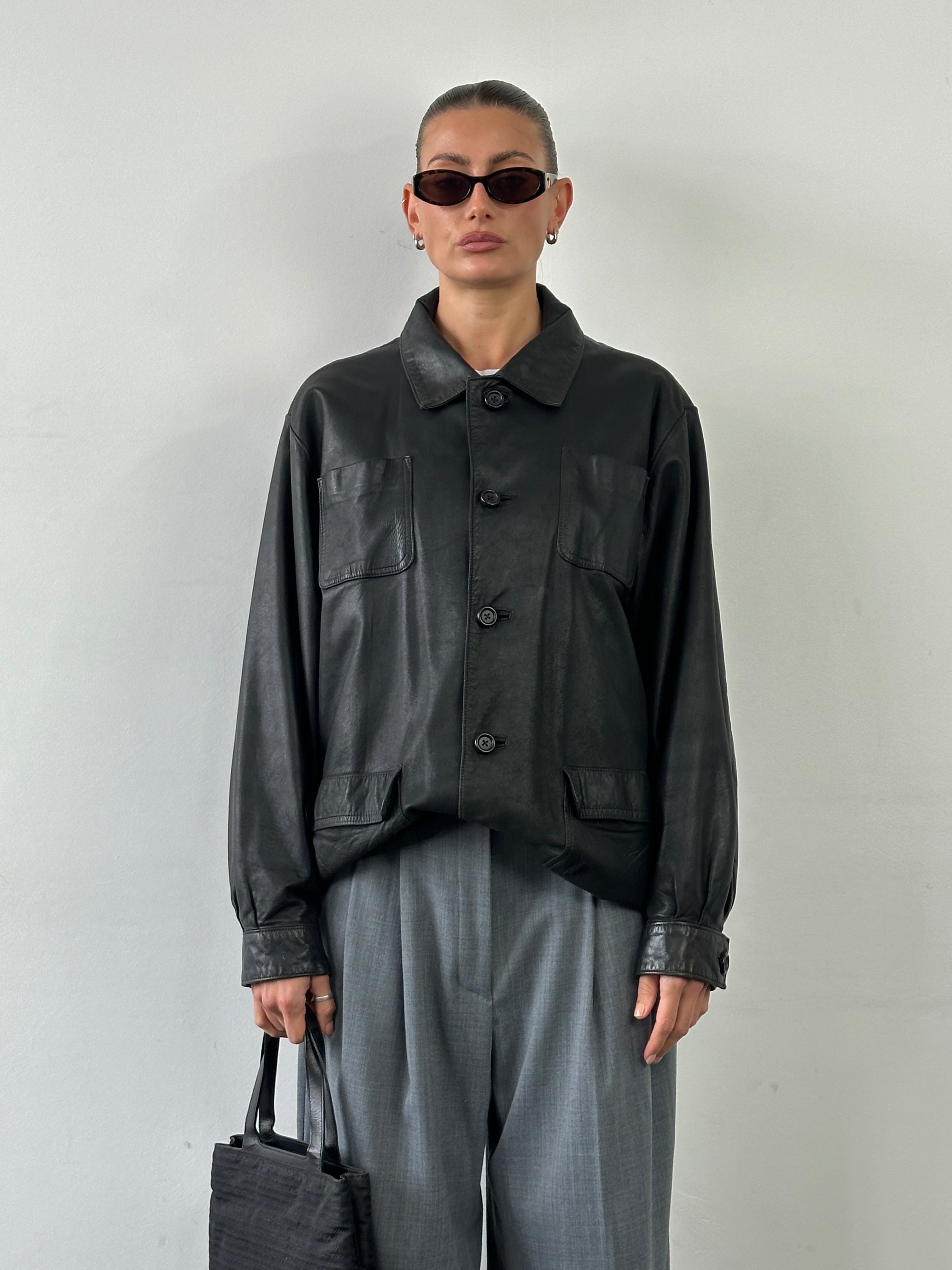 Vintage leather minimal bomber jacket in XL, showcasing a classic design with smooth leather texture and minimal detailing.