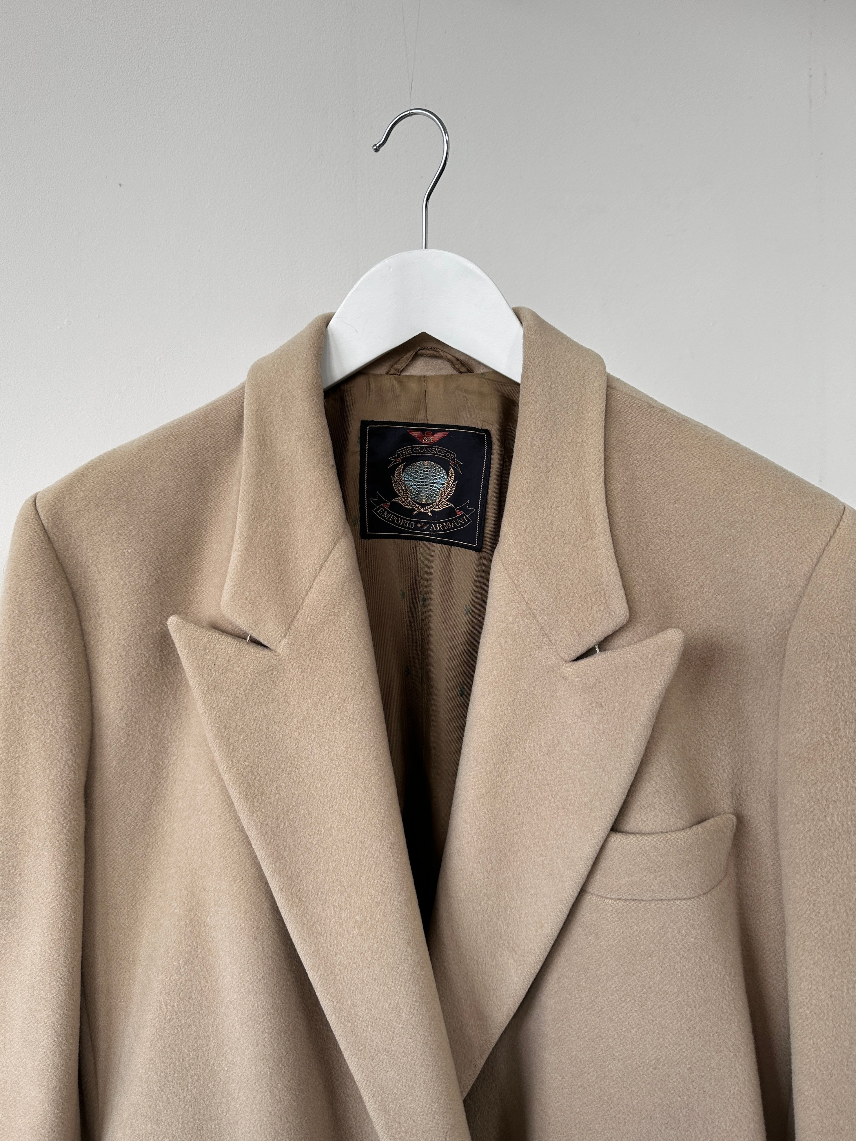 Emporio Armani wool cashmere single-breasted coat in size S, displayed on a hanger, showing classic tailored design and neutral color