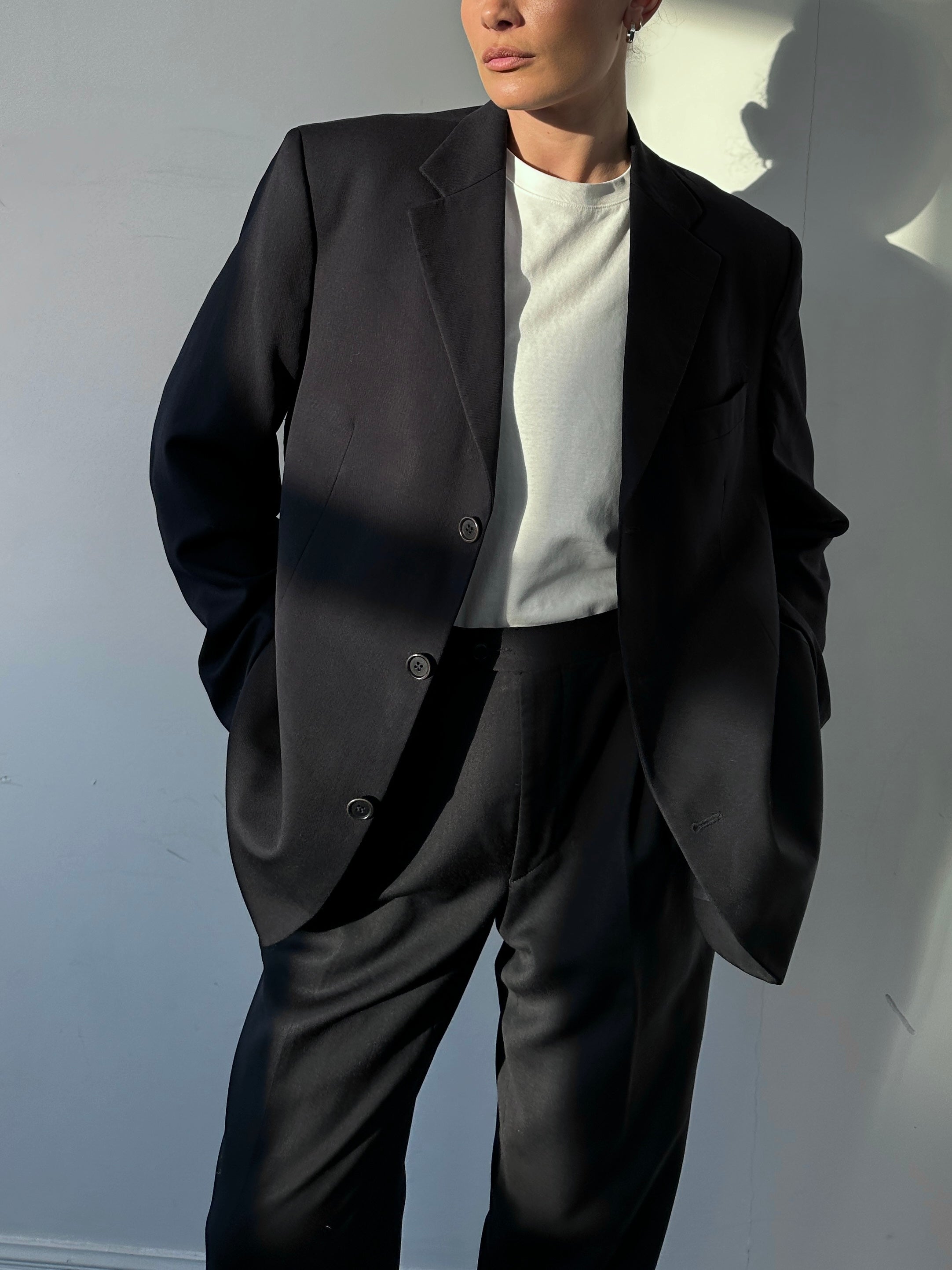 Yves Saint Laurent pure wool single-breasted blazer in black, tailored fit with notch lapel and front button closure.