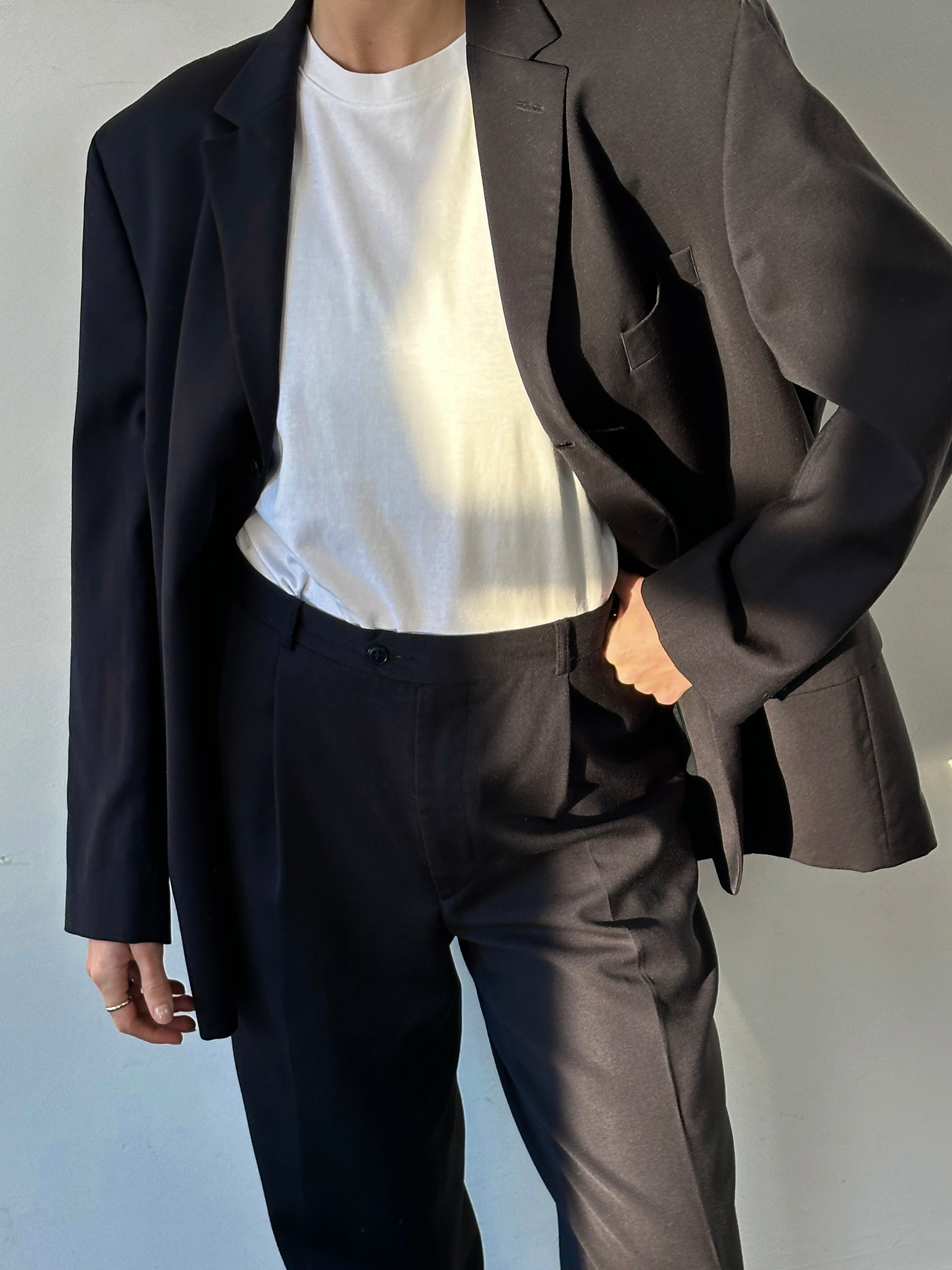 Pierre Cardin pure wool single-breasted jumpsuit in size 44S/W32, shown on a hanger with detailed fabric texture.