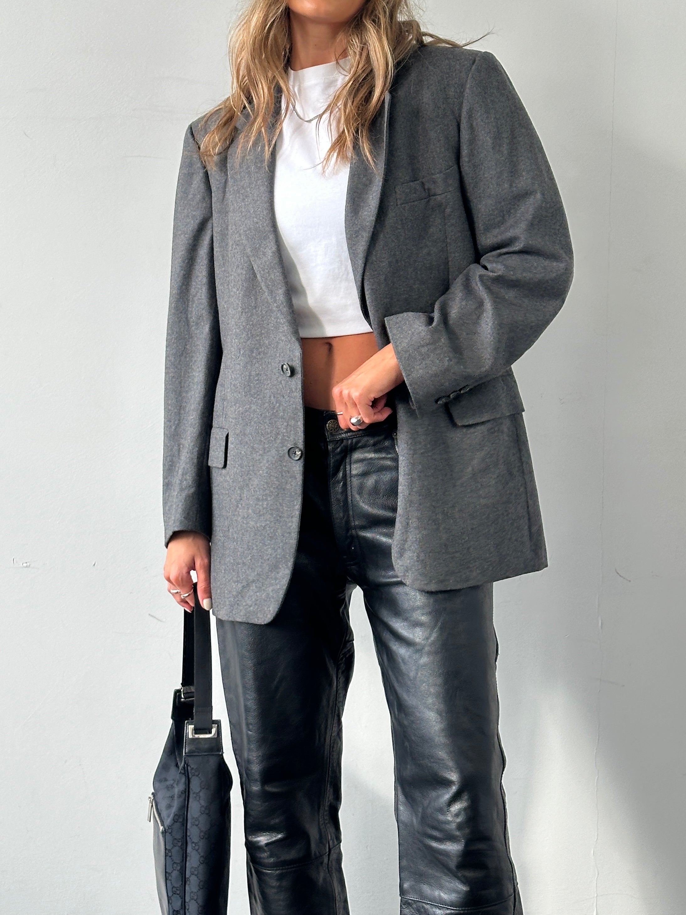 Christian Dior pure wool blazer in size L, tailored fit with classic lapels and button closure, displayed on a neutral background.