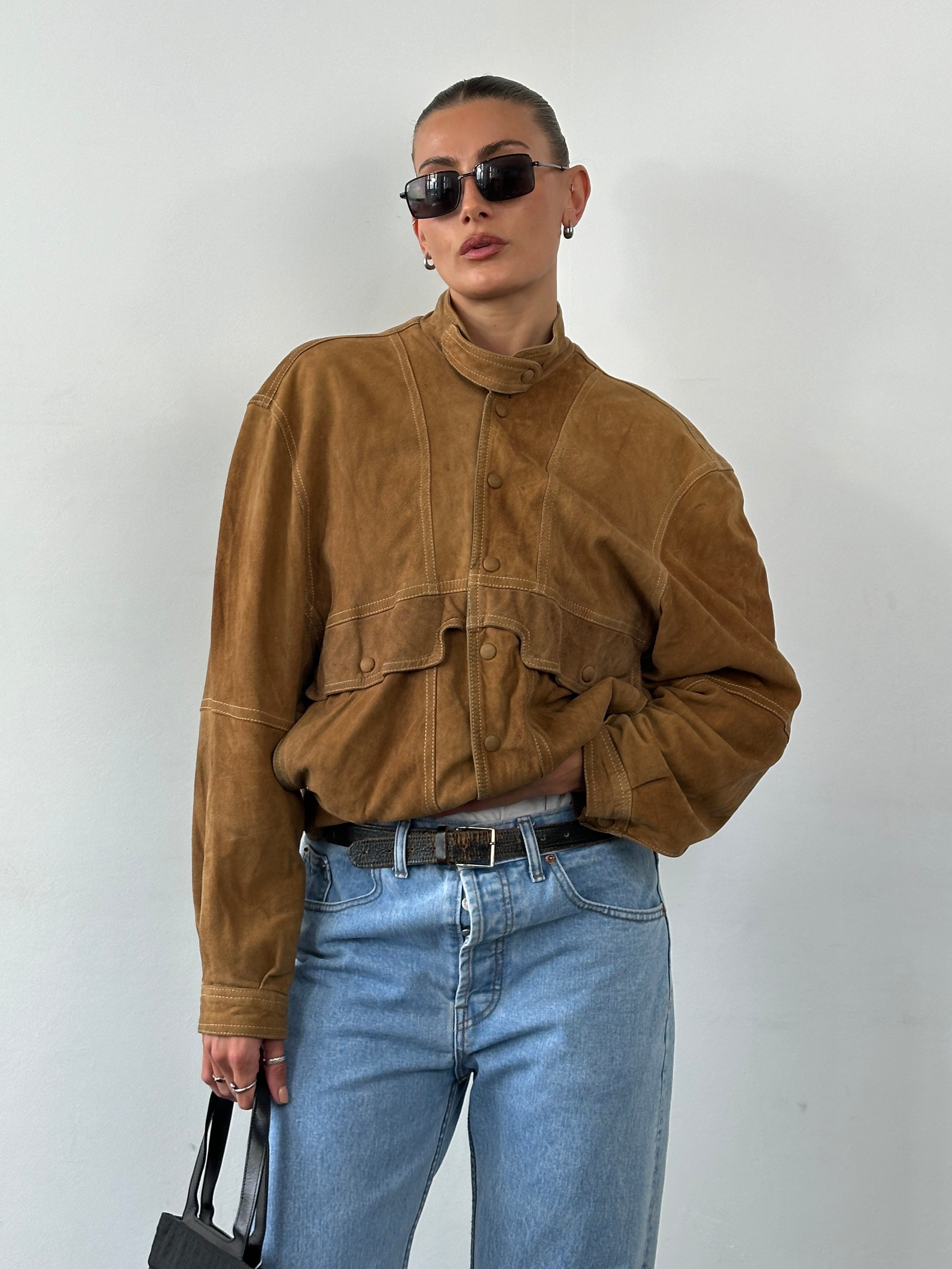 Vintage high-neck suede bomber jacket, size M, featuring a classic design with a smooth suede finish and ribbed collar.