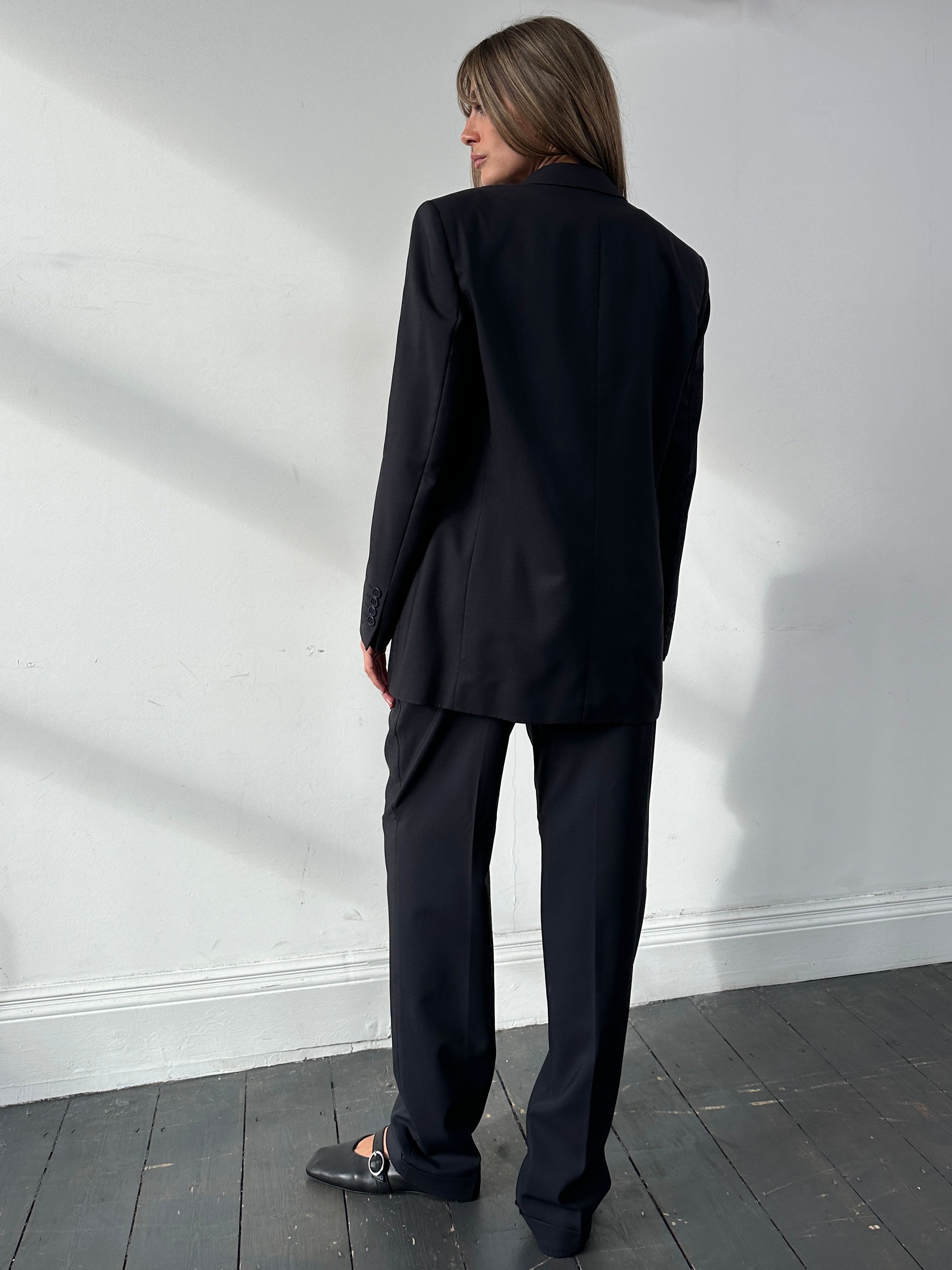 Yves Saint Laurent Pour Homme wool single-breasted suit in size 38R/W30, displayed on a hanger, showing the tailored fit and fabric texture.