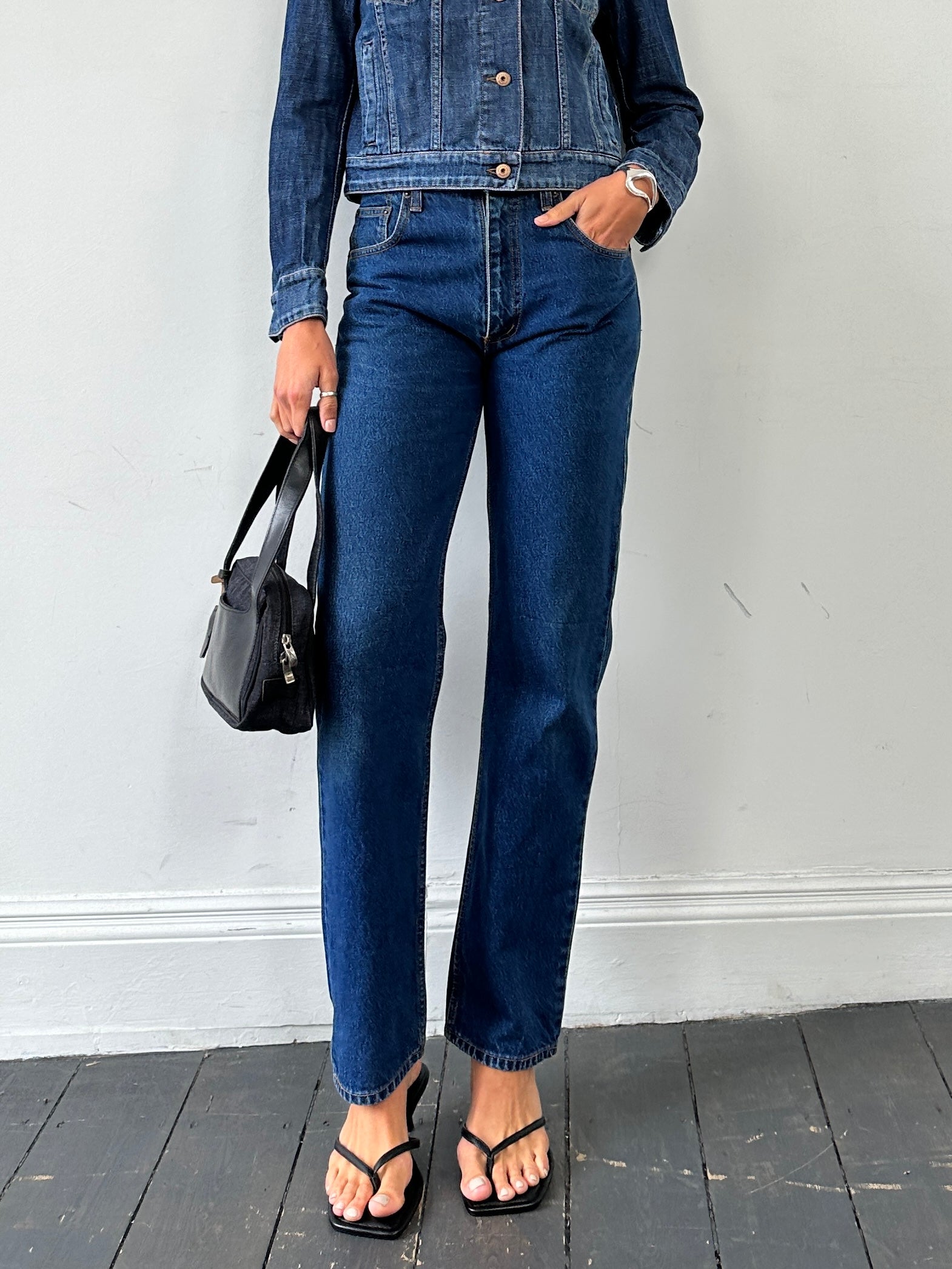 Vintage pure cotton straight leg denim jeans in size W28, showing classic blue wash and fitted style.