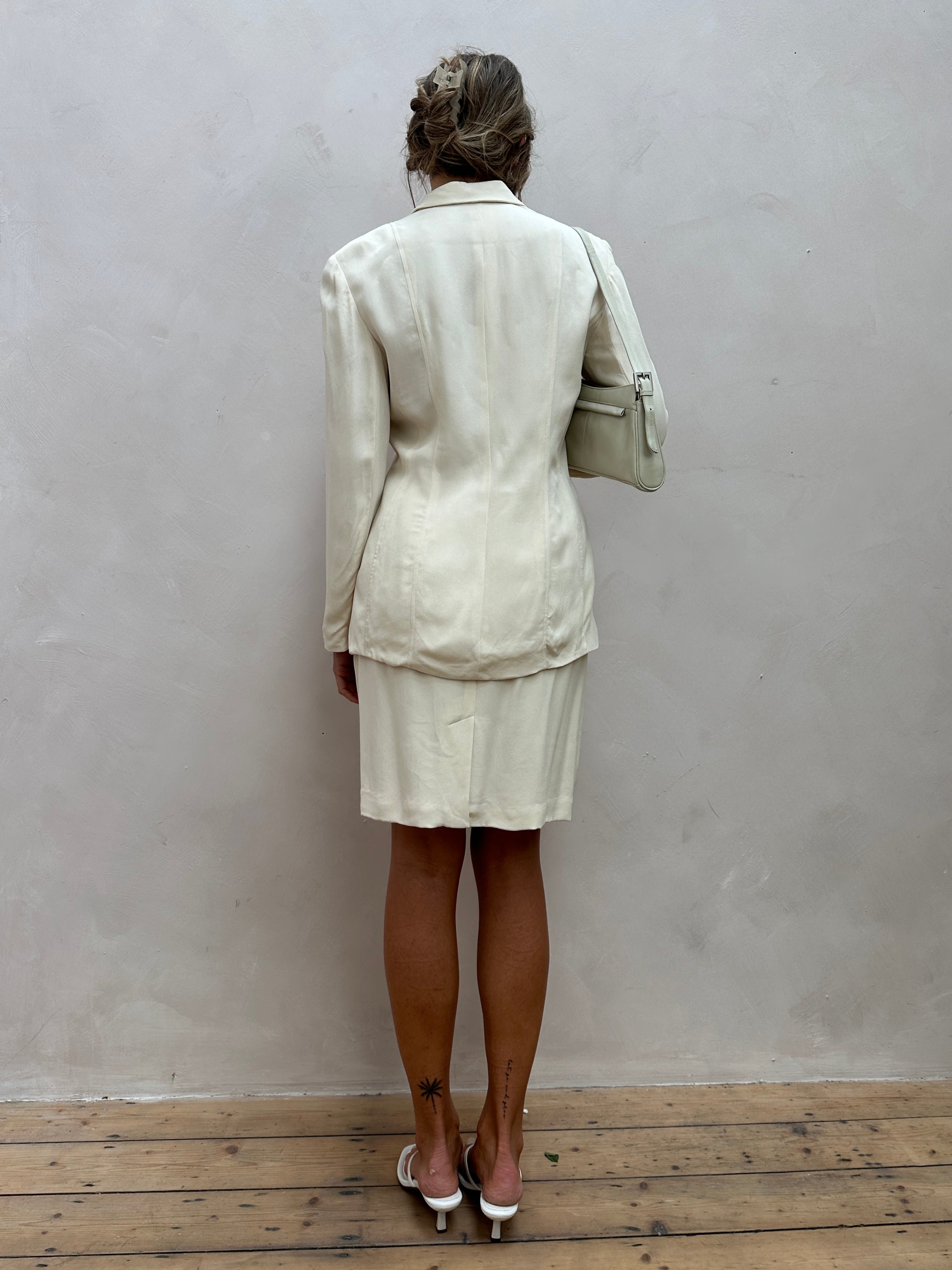 Vintage two-piece silk blazer and skirt suit set, featuring a classic blazer and matching skirt in elegant fabric.