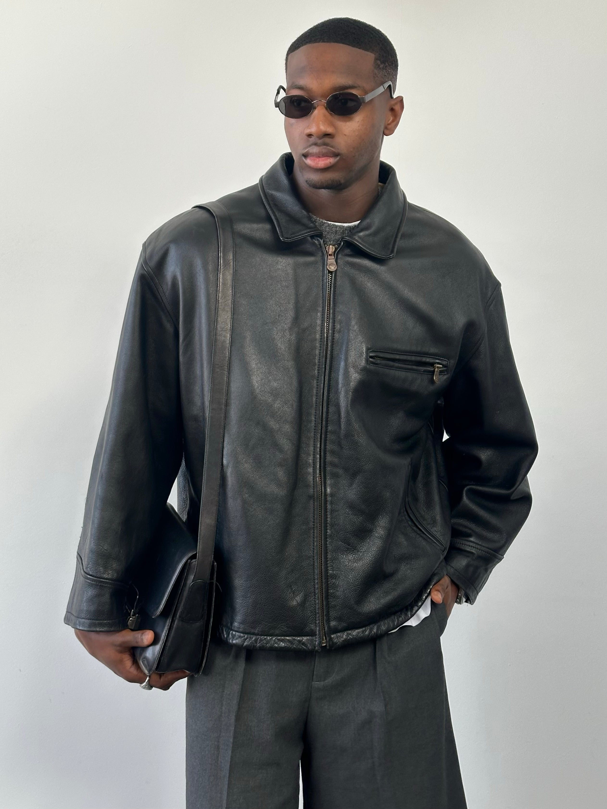 Vintage 1990s heavyweight leather jacket in black, minimal style, with classic collar and front zipper, XXL size.
