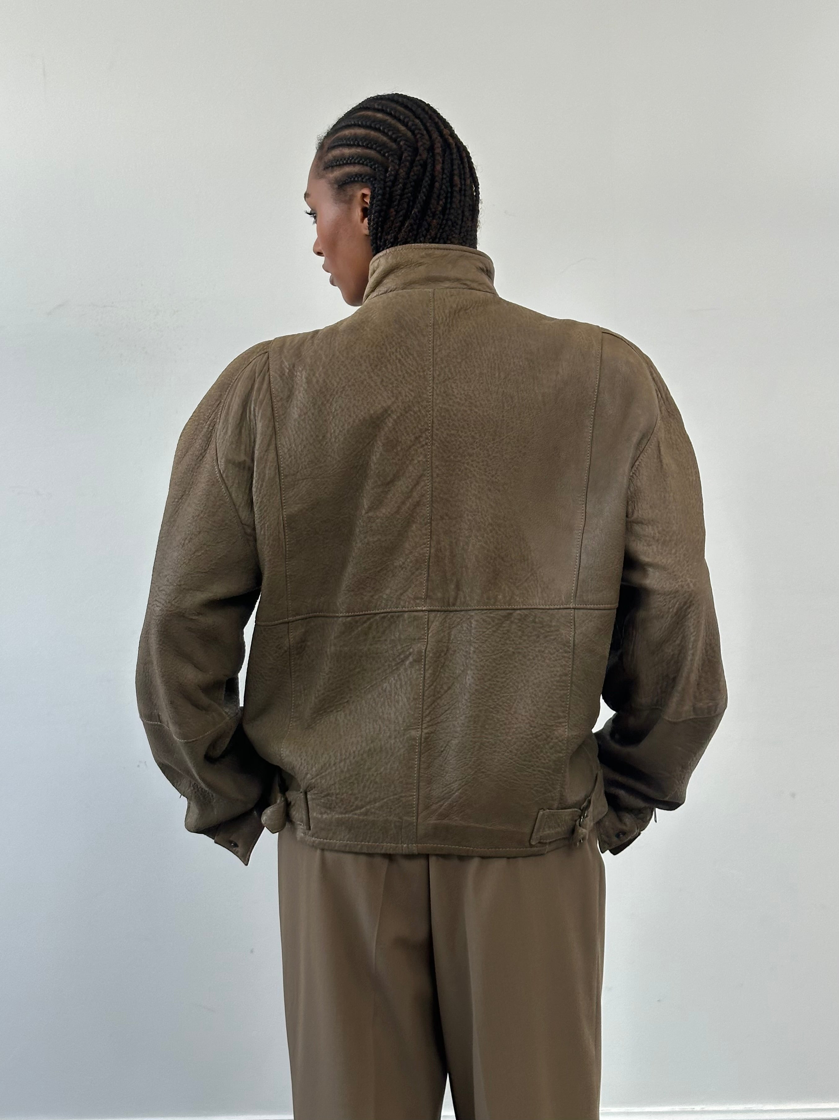 Vintage 1980s leather moto jacket in size large, featuring classic biker style with zippers and a distressed leather finish.