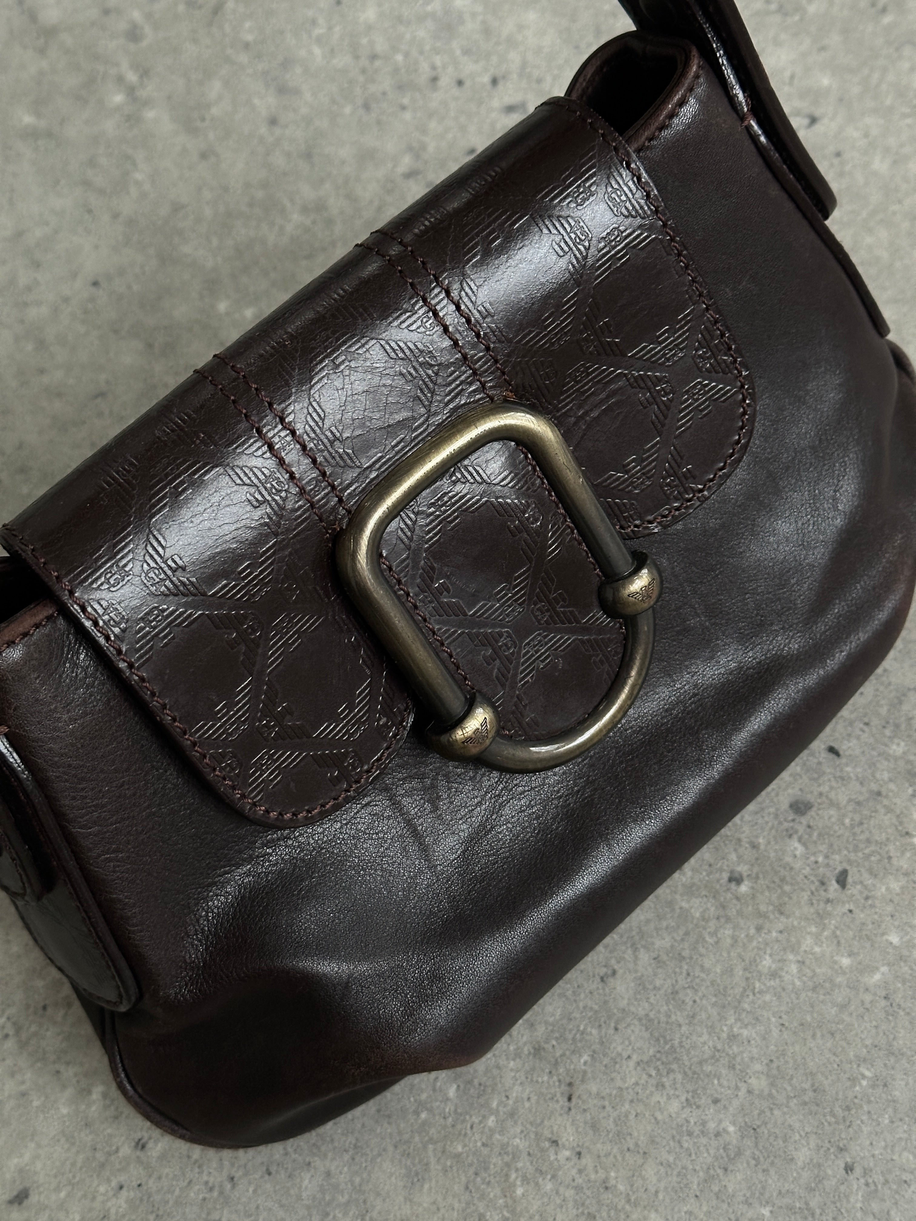 Emporio Armani leather shoulder bag with hardware monogram design, featuring structured shape and adjustable strap.