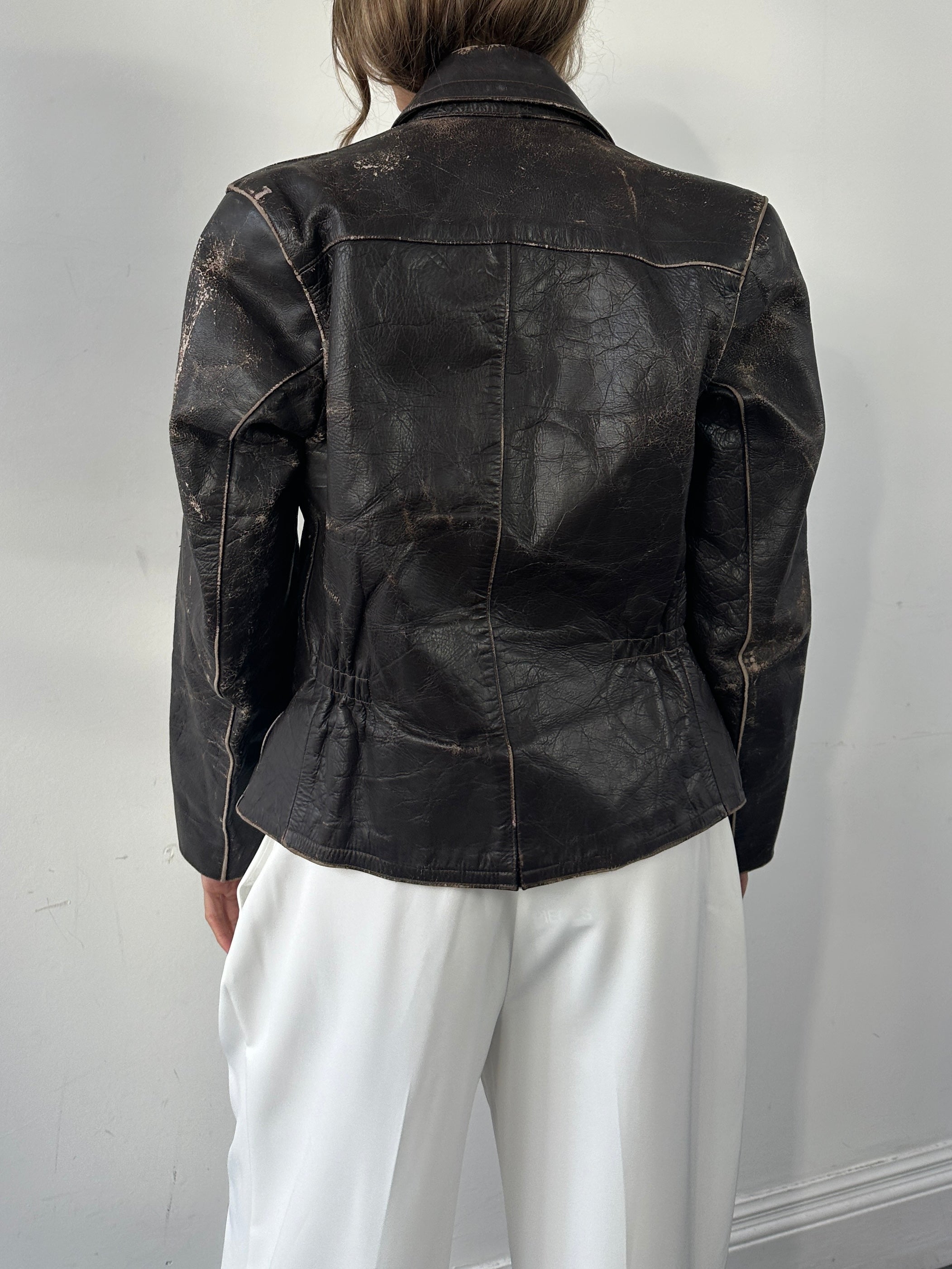 Vintage distressed leather jacket in size S/M, structured design with a rugged, worn-in look and classic style.