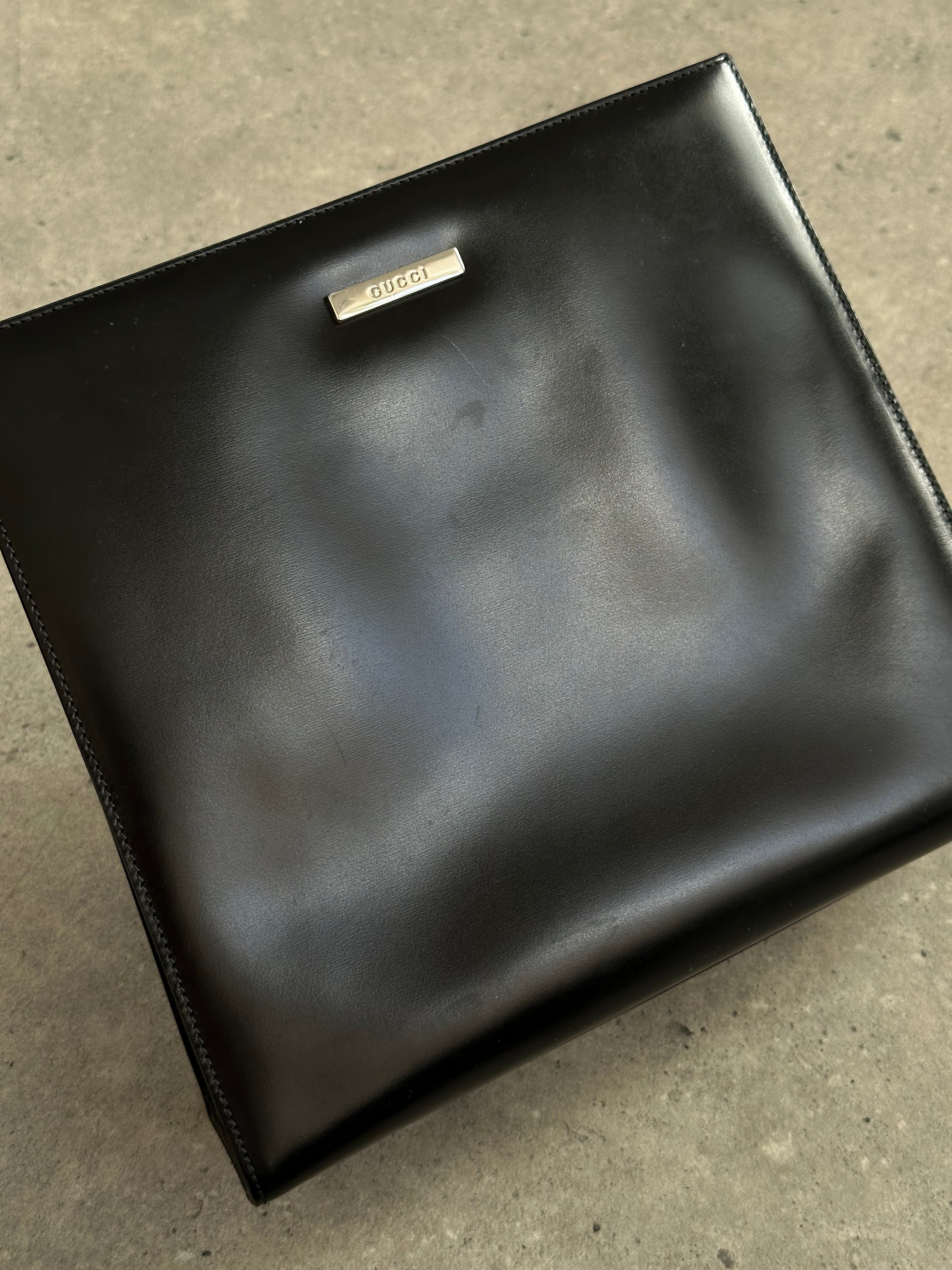Gucci 1990s Tom Ford 2-in-1 leather and vinyl handbag with structured design and top handle, featuring classic Gucci style.