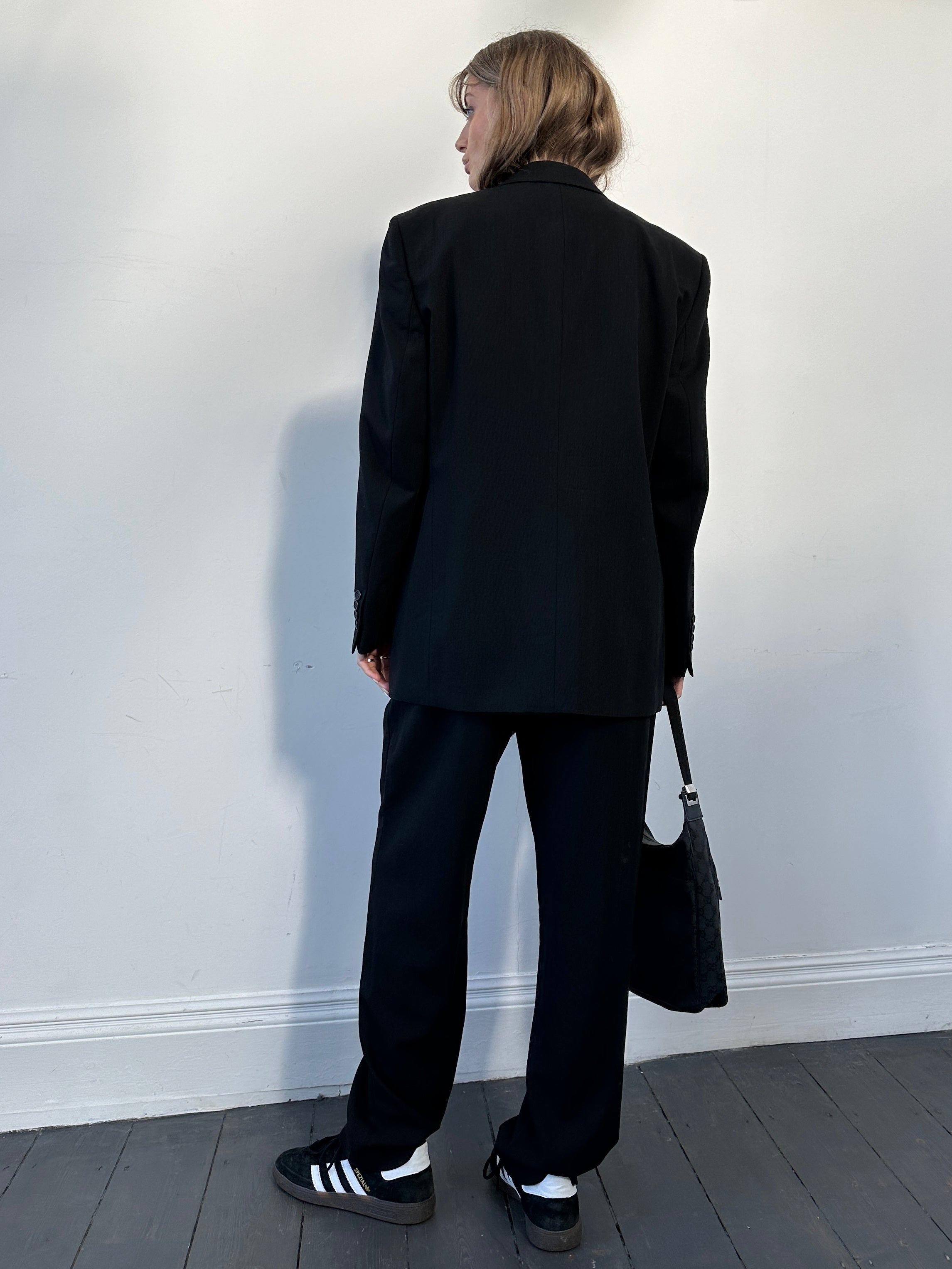 Yves Saint Laurent pure wool jumpsuit in size 42R/W32, tailored fit with elegant lapel and full-length sleeves.